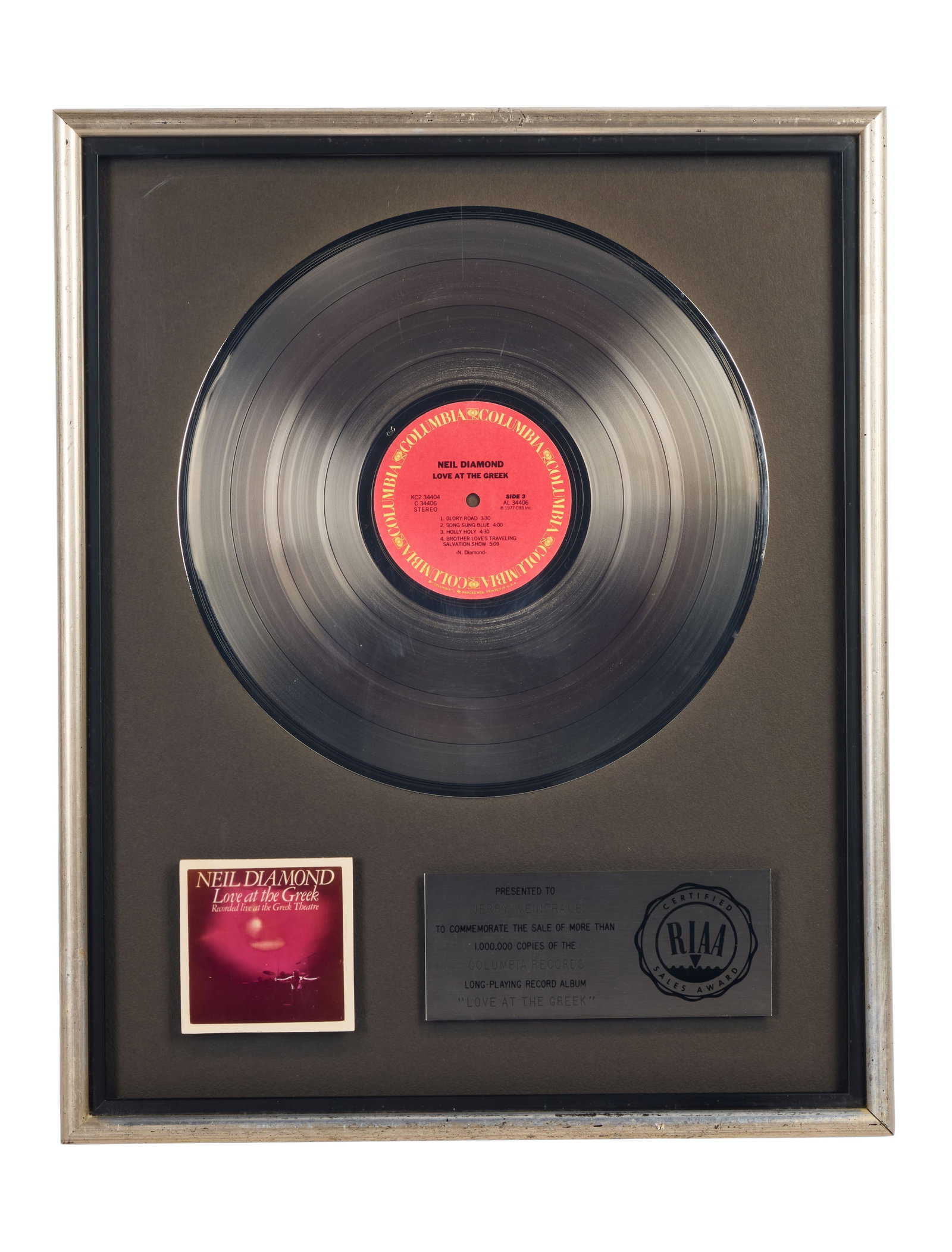 Neil Diamond | RIAA-Certified "Platinum" Sales Award for "Love at the Greek" Presented to Jerry: An RIAA-Certified "Platinum" Sales Award presented to concert promoter and producer Jerry Weintraub to commemorate the sale of more than 1,000,000 copies of Neil Diamond's long-playing record
