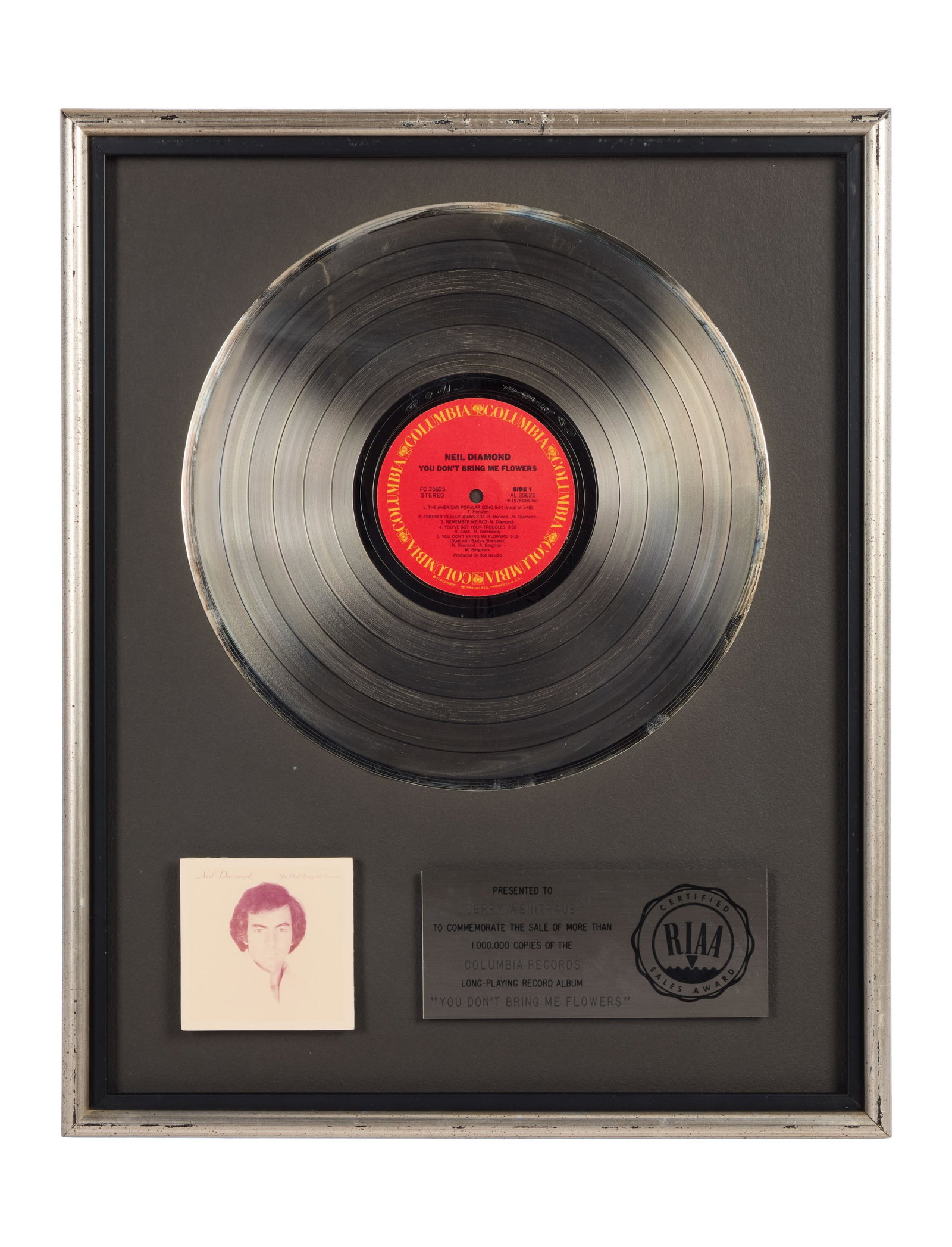Neil Diamond | RIAA-Certified "Platinum" Sales Award for "You Don't Bring Me Flowers" Presented to: An RIAA-Certified "Platinum" Sales Award presented to concert promoter and producer Jerry Weintraub to commemorate the sale of more than 1,000,000 copies of Neil Diamond's long-playing record