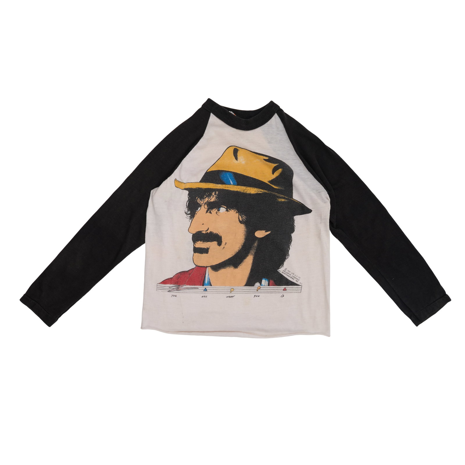Ed Mann | "You Are What You Is" Frank Zappa North American Tour Raglan T Shirt: Ed Mann's personal t-shirt (Size S) from the 1981 "You Are What You Is" North American tour. The Plymouth raglan t-shirt features a screen-printed image of Frank Zappa on the front and the Barking