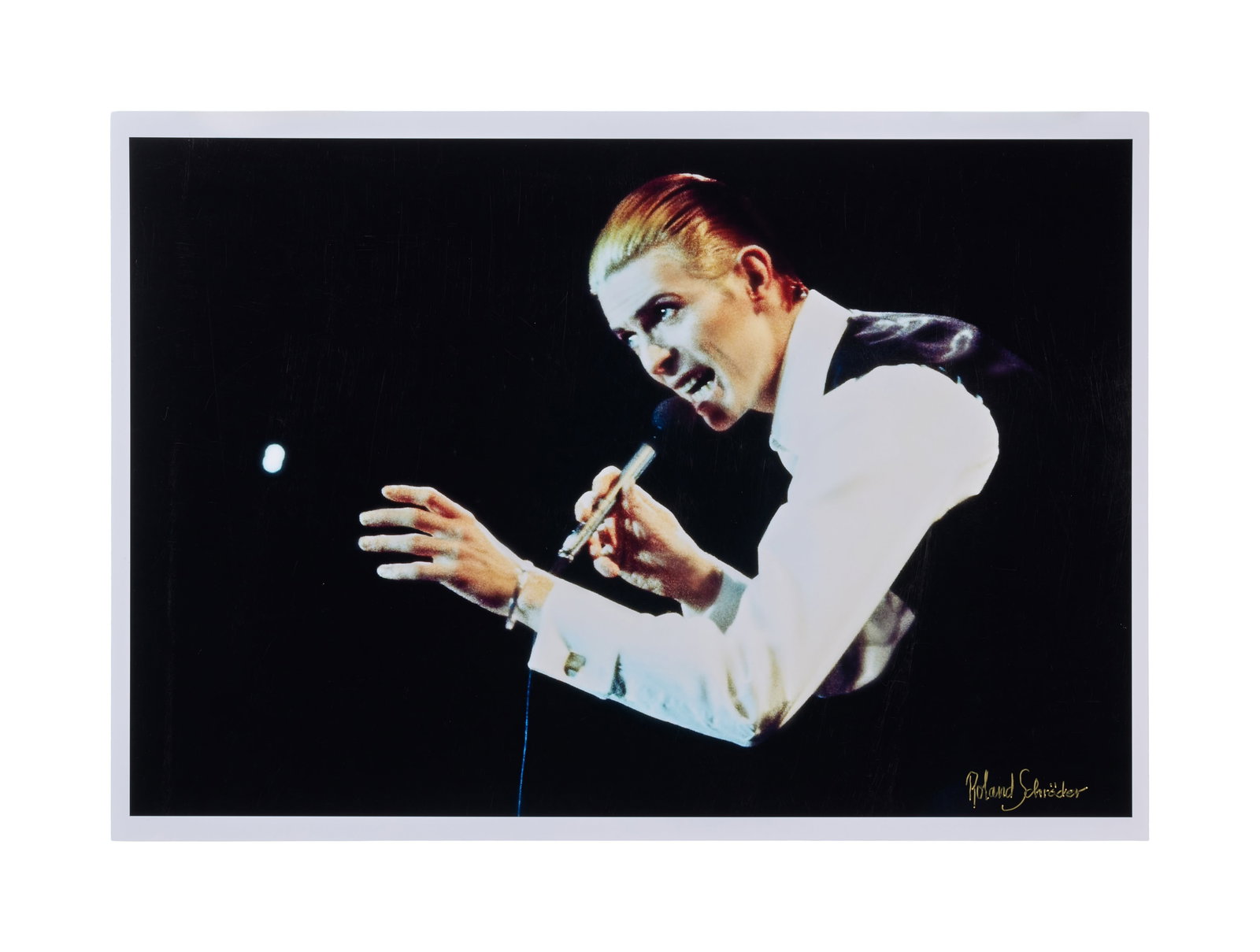 David Bowie | Live Photo Print Signed By Photographer Roland Schroder: A print of David Bowie taken during his performance at the Empire Pool (now known as Wembley) on May 3rd, 1976. The image was taken by Roland Schr?der who has signed the print.