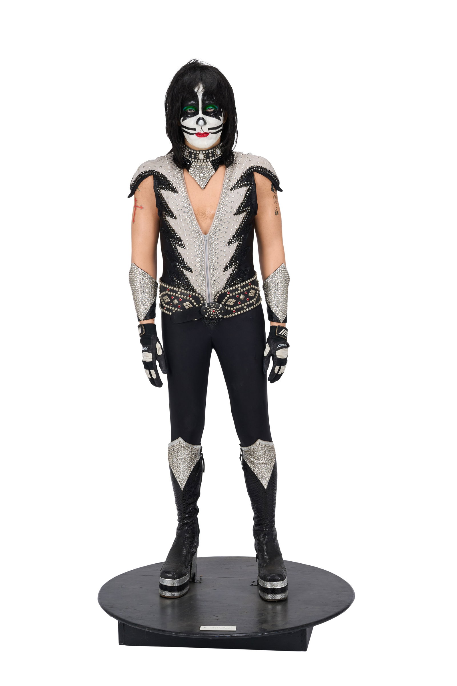 KISS | Peter Criss Life-Size Destroyer Costume Mannequin: A life-size custom mannequin created with a life cast of Peter Criss of KISS, including a detailed silicone life cast head and hands, by Joe Petra. The mannequin is displayed on a wooden circular base