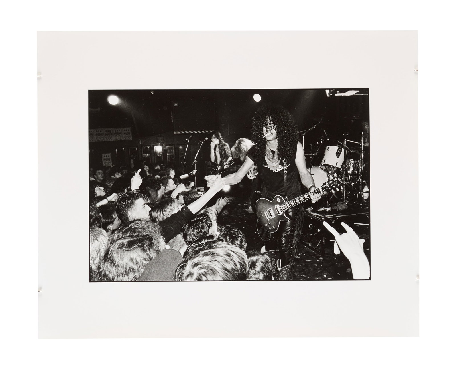 Guns N' Roses | 1987 Marquee London Photo Print by Richard Bellia: A silver gelatin print featuring Slash with Guns N' Roses performing on-stage in June of 1987 at the Marquee Club in London, UK, taken by photographer Richard Bellia. Photographer's stamp on the verso