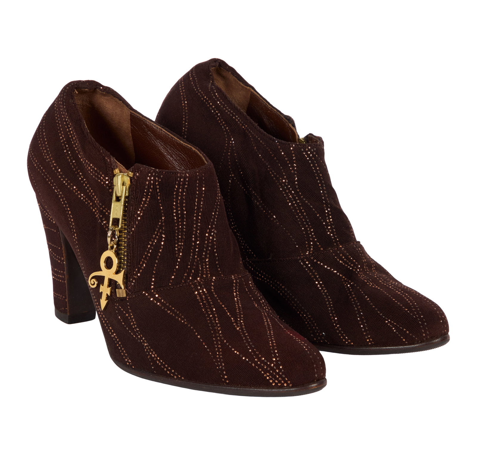 Prince | 1990s Custom-Made Boots: A pair of custom-made brown booties with metallic embellishments and a gold-tone "Love Symbol #2" zipper pull attachment, made for Prince, c. 1990s. Labeled "Andre #1 Made in U.S.A." The booties match