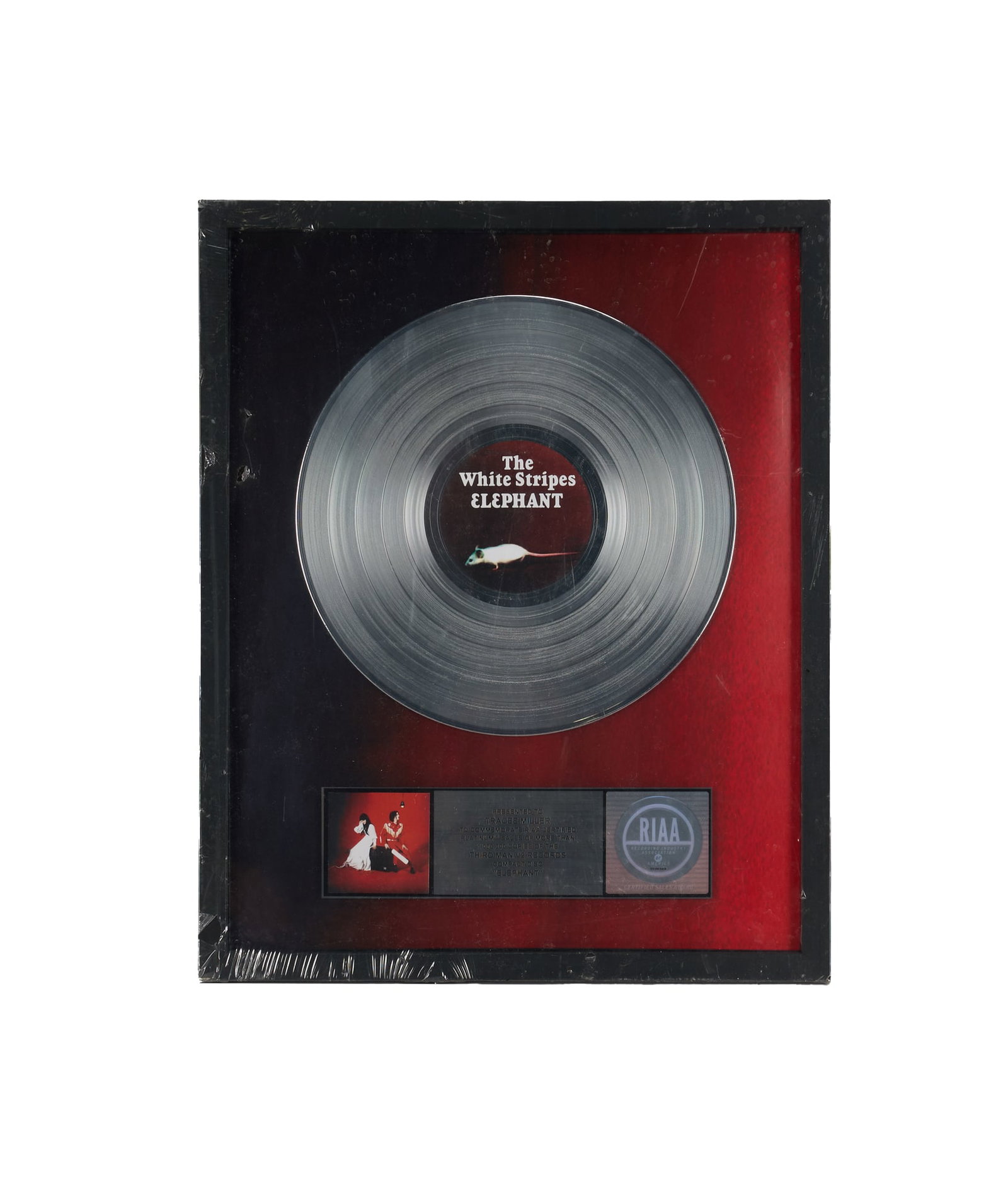 The White Stripes | RIAA Certified "Platinum" Sales Award for "Elephant" Presented to Tracee Mae: An RIAA-Certified "Platinum" Sales Award presented to Tracee Mae Miller to commemorate more than 1,000,000 CD copies of The White Stripes' 2003 studio album Elephant. Released on April 1, 2003, 