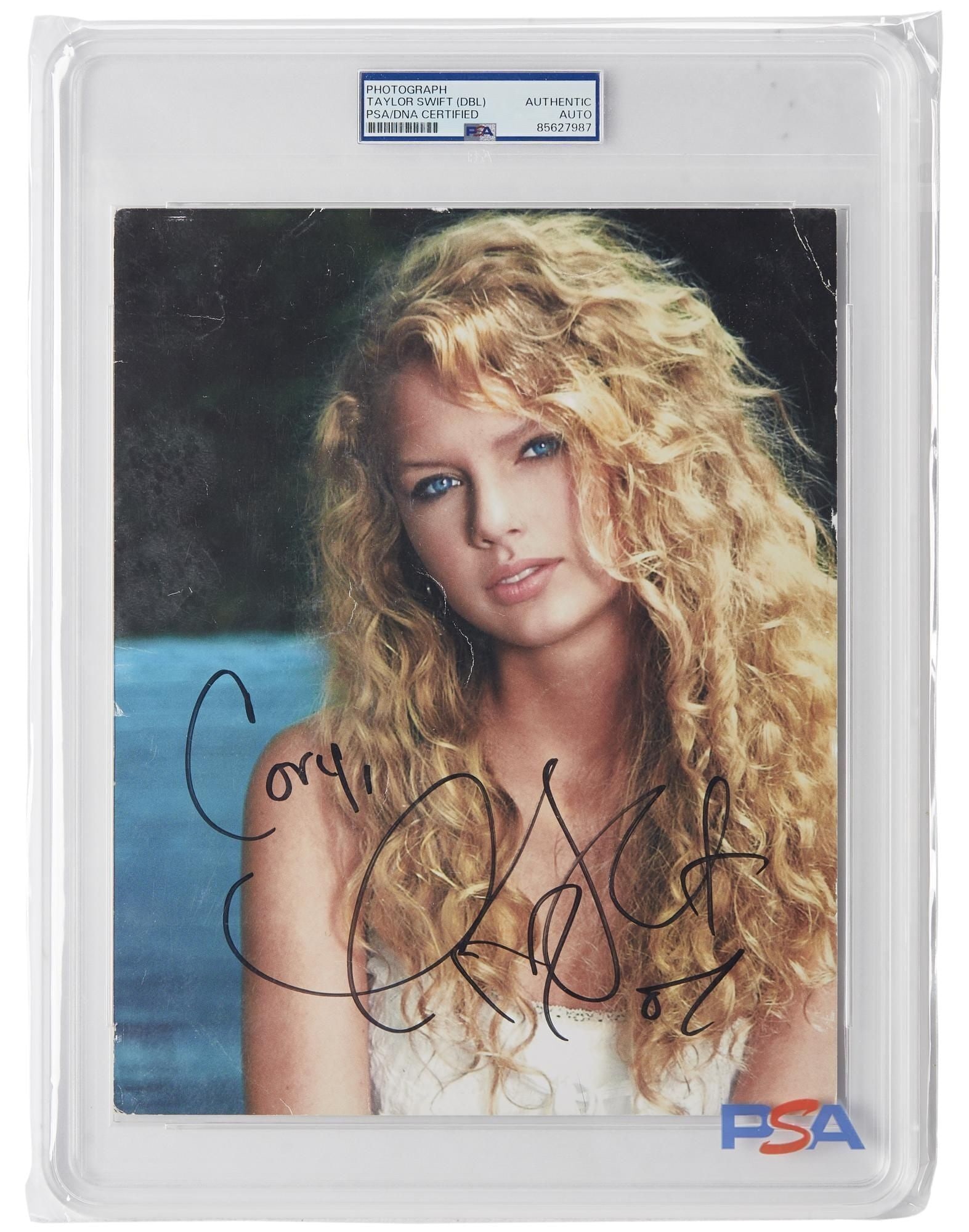 Taylor Swift | 2007 Twice Signed Promo Photo: A 2007 debut-era color promotional photograph of Taylor Swift, signed by her in black marker, with a cartoon drawn by the original recipient on the verso, and an additional signature from Taylor. The 
