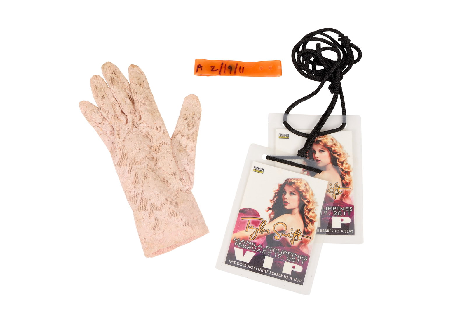 Taylor Swift | 2011 "Speak Now" Tour Stage-Worn Glove: A pale pink lace glove, stage-worn by Taylor Swift on February 19, 2011, performing a sold-out show at the Smart Araneta Coliseum in Quezon City, Philippines. Together with two V.I.P passes and an ora