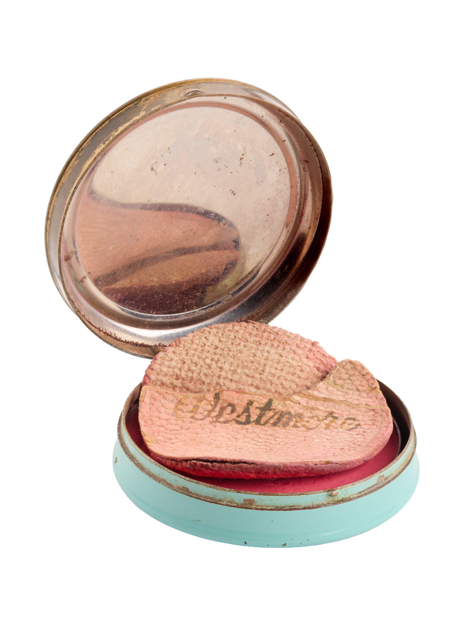 Marilyn Monroe | 1952 Rouge by House of Westmore: A small round metal container; sky blue bottom with a gold-tone metal lid stamped "Westmore / Hollywood," similar stamp on bottom, inside still contains a partially-used rose-colored powder rouge and 
