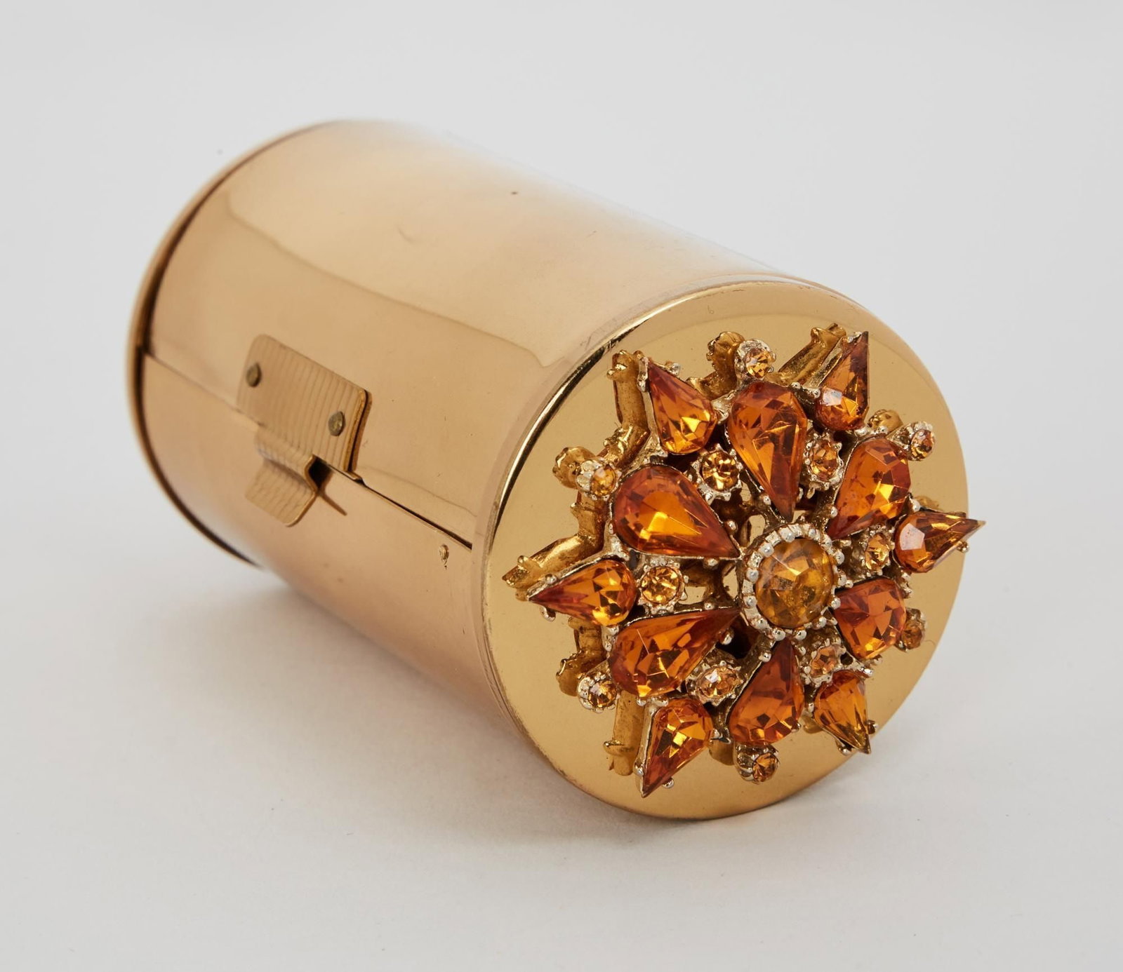 Marilyn Monroe | 1950s Minaudiere Evening Purse: A small cylindrical-shaped piece made of gold-tone metal; either end adorned with an elaborate citrine floret, purse opens to reveal three compartments: the first holds a tiny hair comb and a tube of 