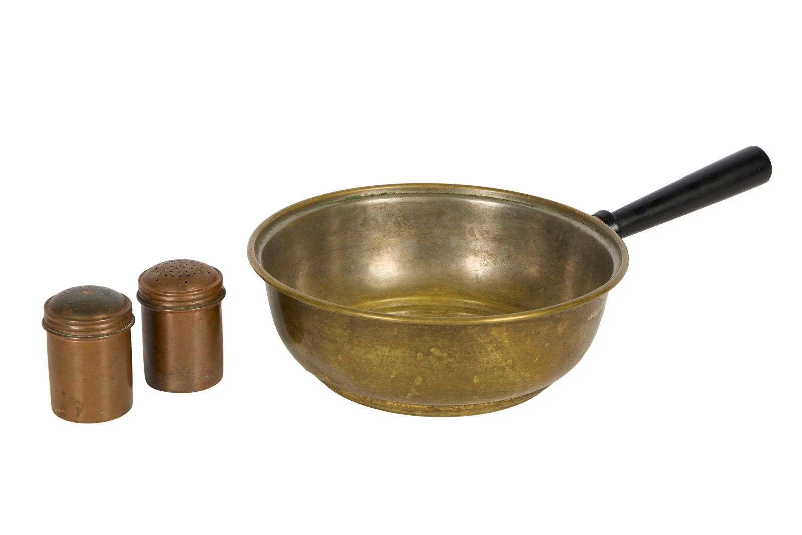 Marilyn Monroe | 1950s Kitchenware: A group of two items; the first a deep brass saucepan with a black-painted handle; the second a pair of copper salt and pepper shakers with screw-on lids; both were originally part of a group lot that