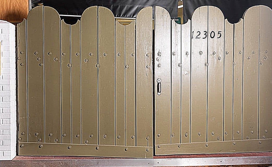 Marilyn Monroe | 1962 Front Gates from Her Fifth Helena Drive Home: A set made of wood; painted olive green, with a dramatic scalloped top border, staggered bolts affixed horizontally across top and bottom of each side, both doors swing inwards at center to open