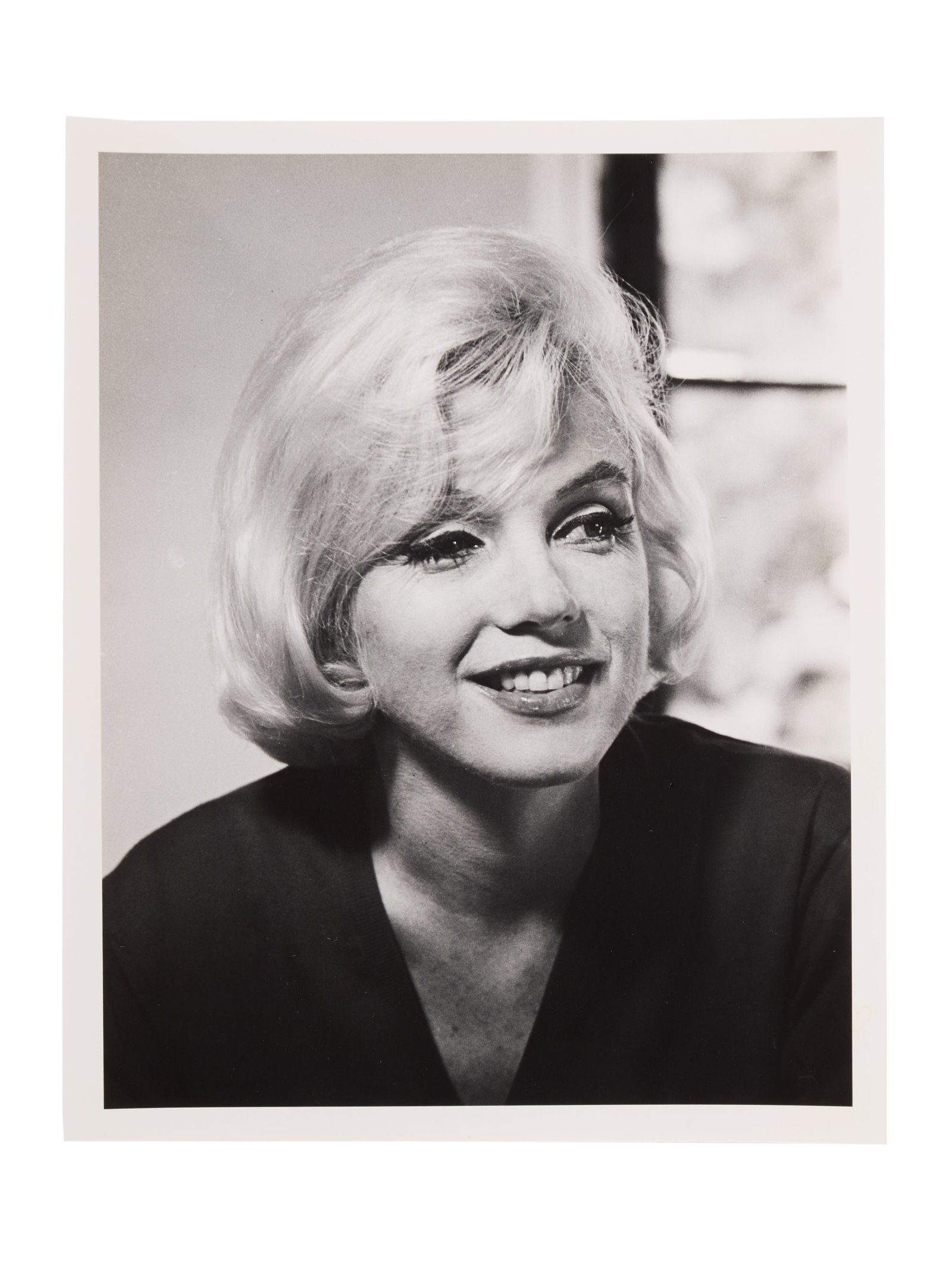 Marilyn Monroe | 1962/1986 Never-Published Black and White Photograph by Allan Grant: A 1986 later print hand-printed by Allan Grant; matte finish, weight-and-a-half paper, depicting a close-up of the star's smiling face as she sits inside her Fifth Helena Drive home in the Brentwood