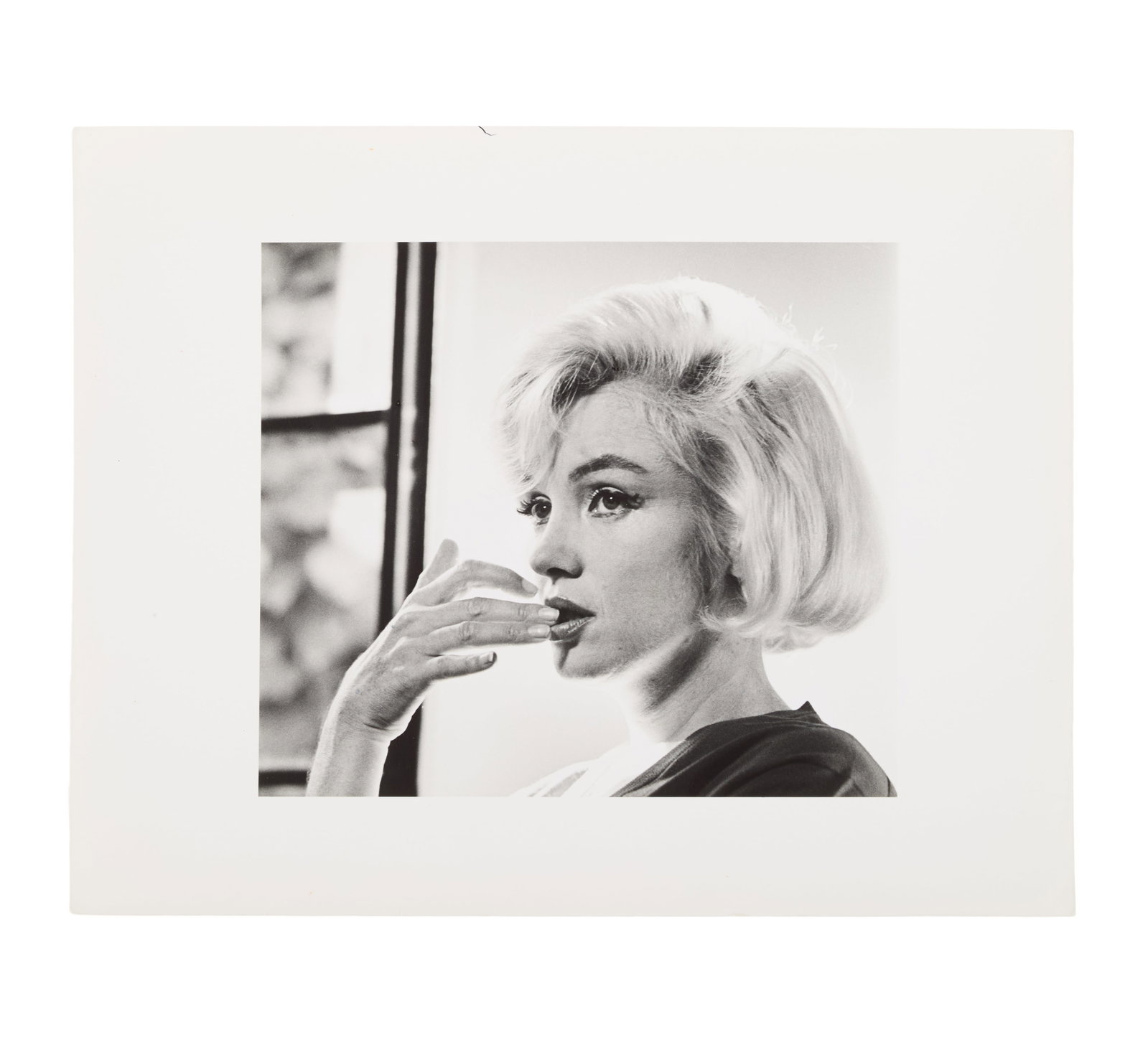 Marilyn Monroe | 1962/1982 Black and White Photograph Signed by Allan Grant: A 1982 later print hand-printed by Allan Grant; unusual format of an 8"x9" printed on 11"x14" paper making wide white borders, semi-gloss finish, double-weight paper, depicting the star looking