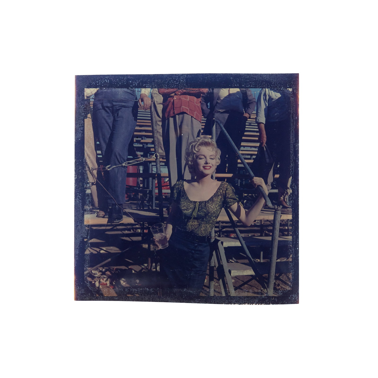 Marilyn Monroe | 1956 Rare Color Transparency from "Bus Stop": 20th Century Fox, 1956; an original print, on film, depicting a beautiful image of the star in a candid moment, holding a glass of water with her eyes closed, crew behind her, while she's on location 