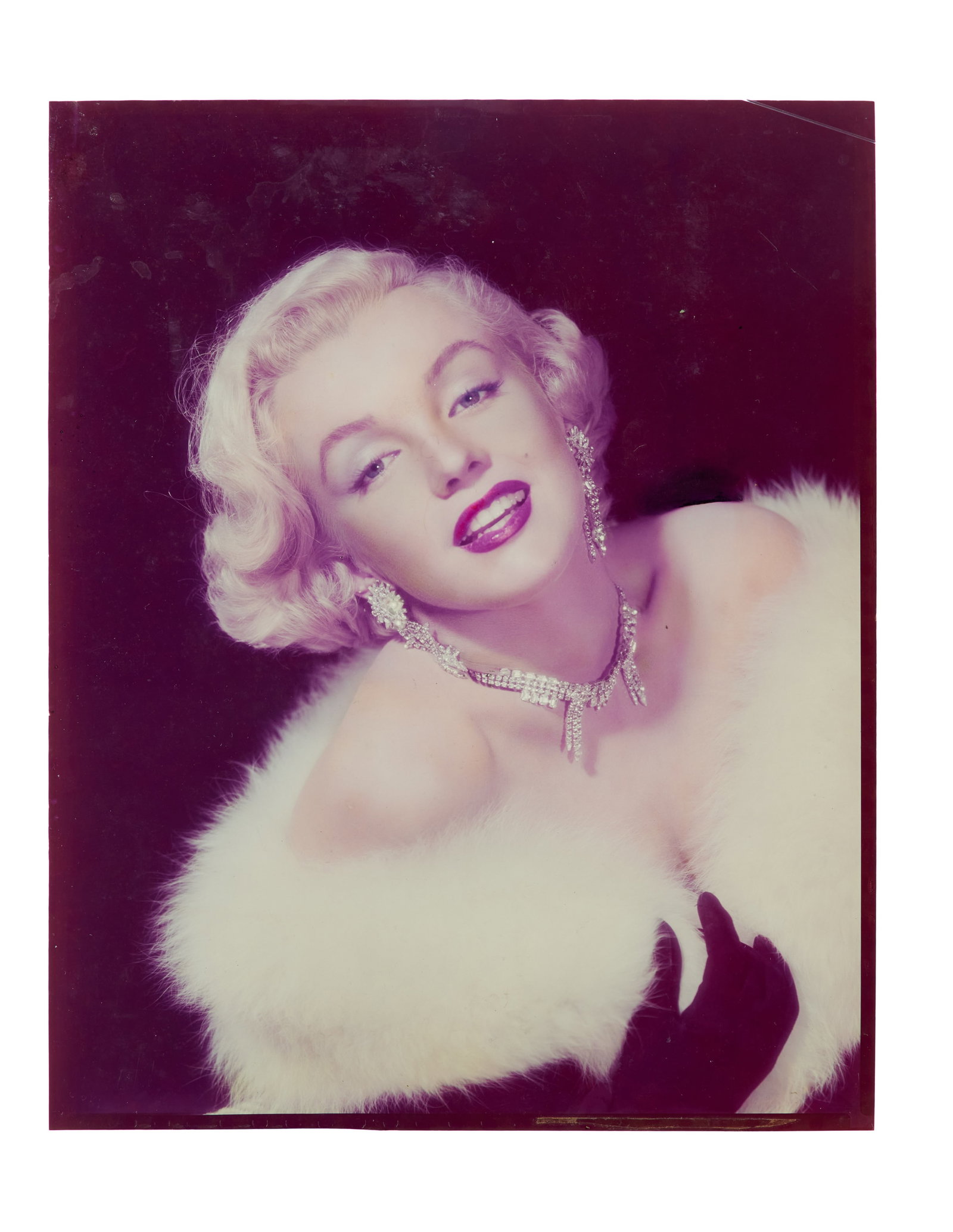 Marilyn Monroe | 1950 Rare Color Transparency: An original print; depicting a stunning headshot of the young starlet wearing a white fur stole, long black gloves, and a rhinestone necklace with coordinating earrings; likely shot by 20th Century