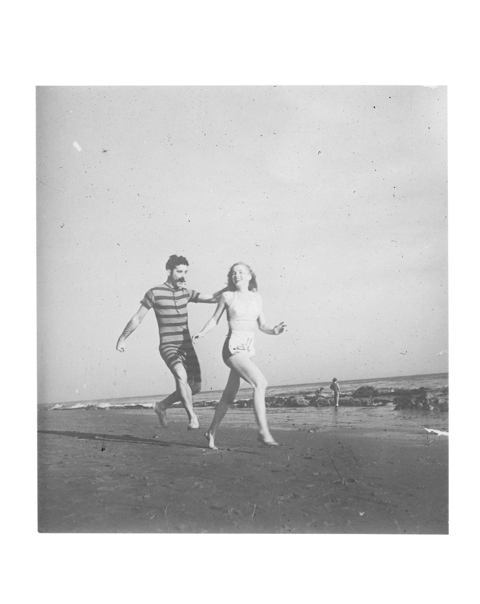 Marilyn Monroe | 1946 Black and White Negative with Copyright by Joseph Jasgur: A large format measuring 5"x4"; depicting the then-called Norma Jeane on Zuma Beach in Malibu wearing her well-known "seagull" bathing suit as she frolics alongside actor Tom Burton; from a series of 