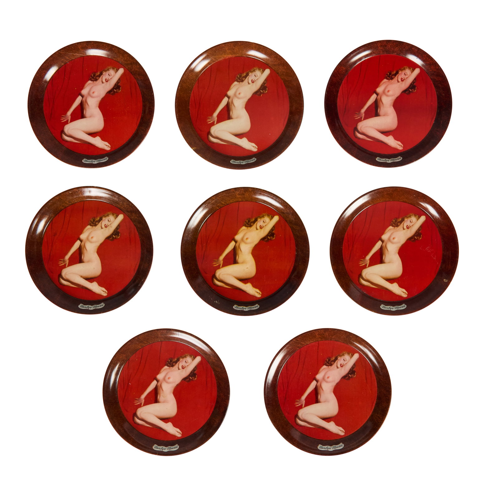 Marilyn Monroe | Circa 1952 Vintage Coasters: A group of eight; made of tin, depicting the instantly recognizable "Golden Dreams" calendar pose that Tom Kelley shot in May of 1949, text below reads "Marilyn Monroe"; these coasters are likely from