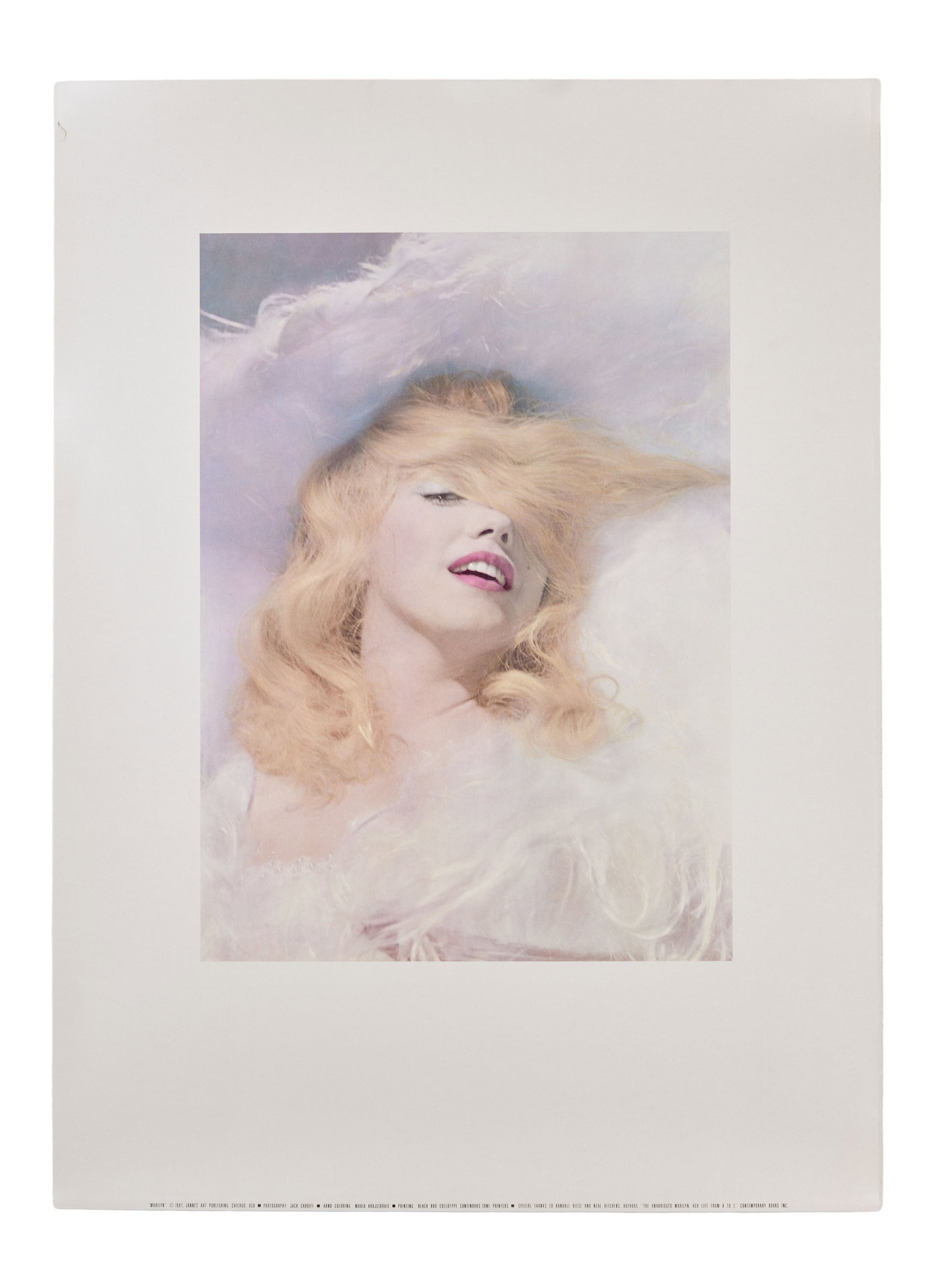 Marilyn Monroe | 1987 Promotional Poster Related to the Book "The Unabridged Marilyn: Her Life from: A piece printed on a quality coated paper stock with a slight shimmer to it; featuring a beautiful colorized image of the star originally shot by Jack Cardiff in 1956 which was used as the illustratio
