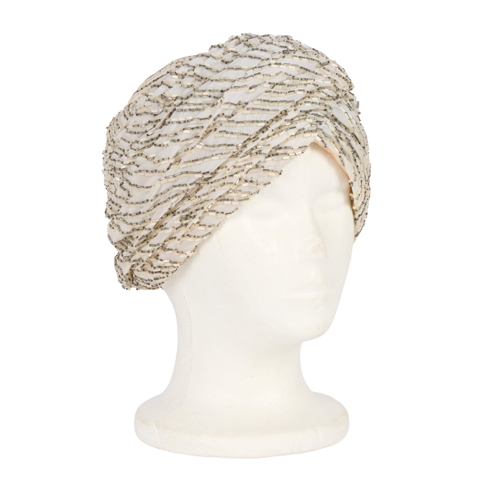 Ann-Margret | 1980s Stage-Worn Turban-Style Hat: An elegant piece made of white silk organza; entirely adorned with silver and white bugle beads, lined in ivory-colored silk, inside label reads "Ann Margret," make-up staining evident on lining;