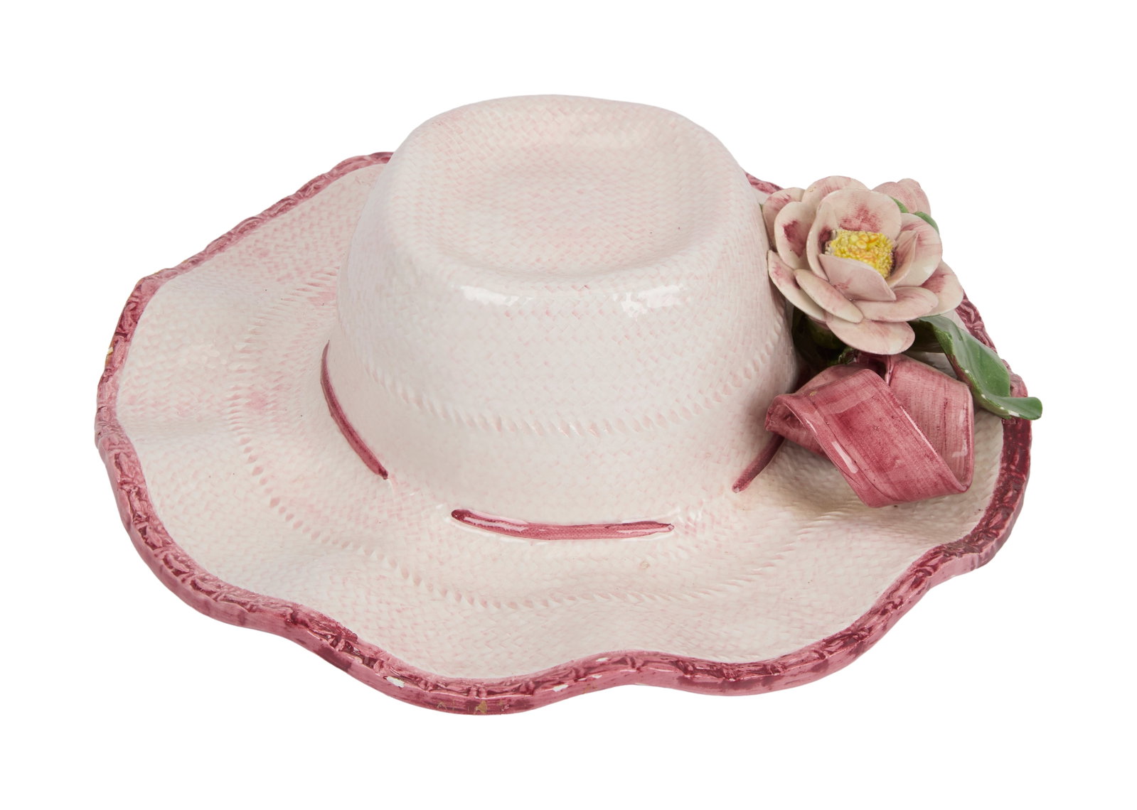 Ann-Margret | 1980s Ceramic Wall Hanging: A whimsical piece in the form of a sun hat; painted pale pink with a flower and ribbon design on front, inside stamped "Made in Italy / For / Seymour-Mann"; Ann-Margret is a fan of hats and wears