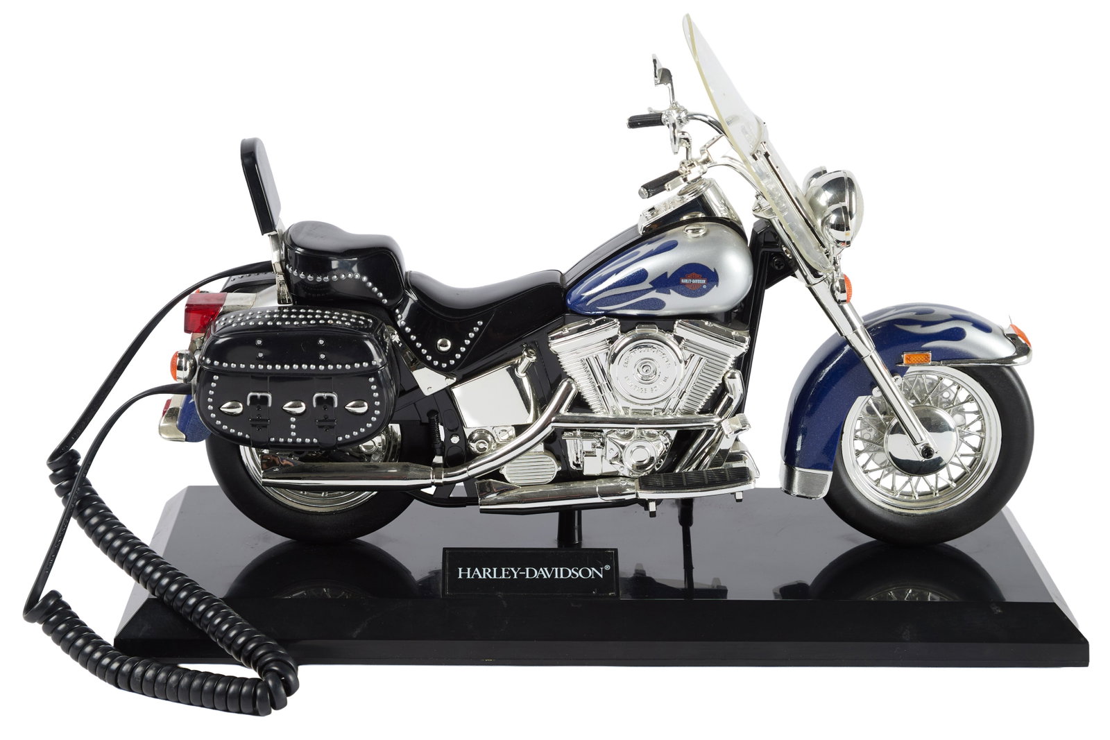 Ann-Margret | 1980s Novelty Harley-Davidson Telephone (I): A whimiscal piece in the form of a motorcyle; with blue and silver detailing, the handset is the seat portion which lifts to reveal the push-button keypad below; affixed to a black rectangular base wi