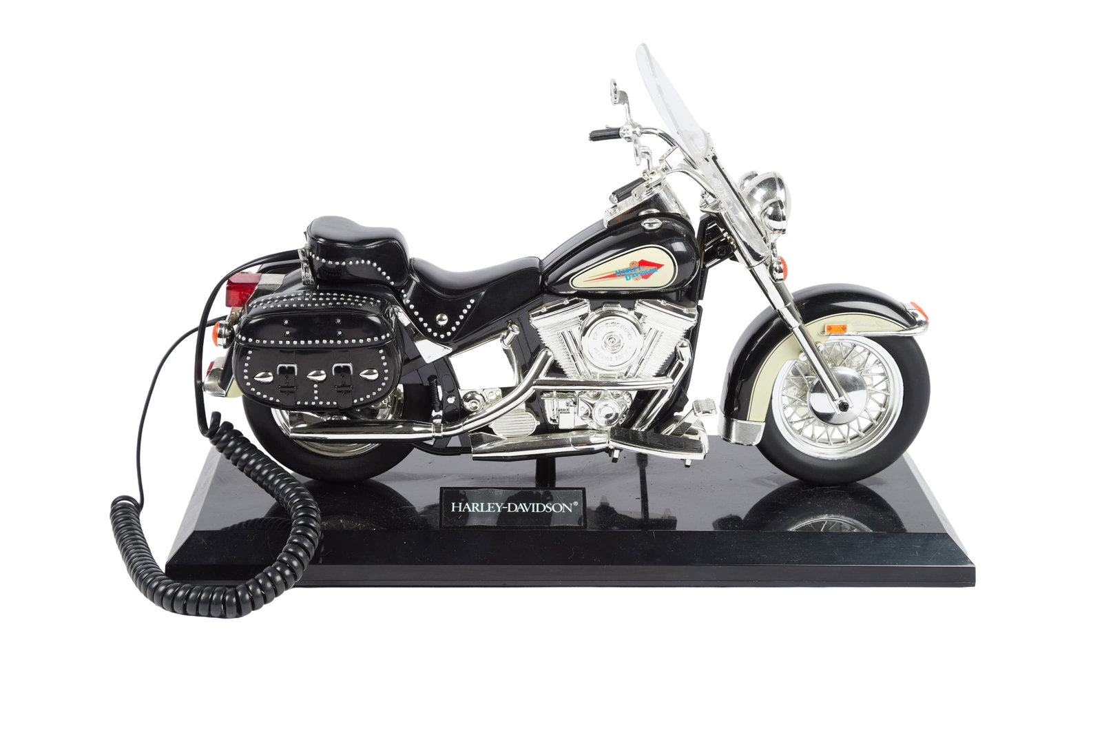 Ann-Margret | 1980s Novelty Harley-Davidson Telephone (II): A whimiscal piece in the form of a motorcyle; the handset is the seat portion which lifts to reveal the push-button keypad below; affixed to a black rectangular base with a small sign reading "Ha