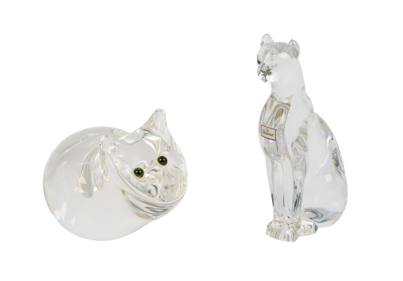 Ann-Margret | 1990s Crystal Cat Figurines: A group of two; the first with added green-tone eyes marked "Steuben," with two cracks in the tail; the second marked "Baccarat / France," with a chip on the back of the left ear; Ann-Margret is a