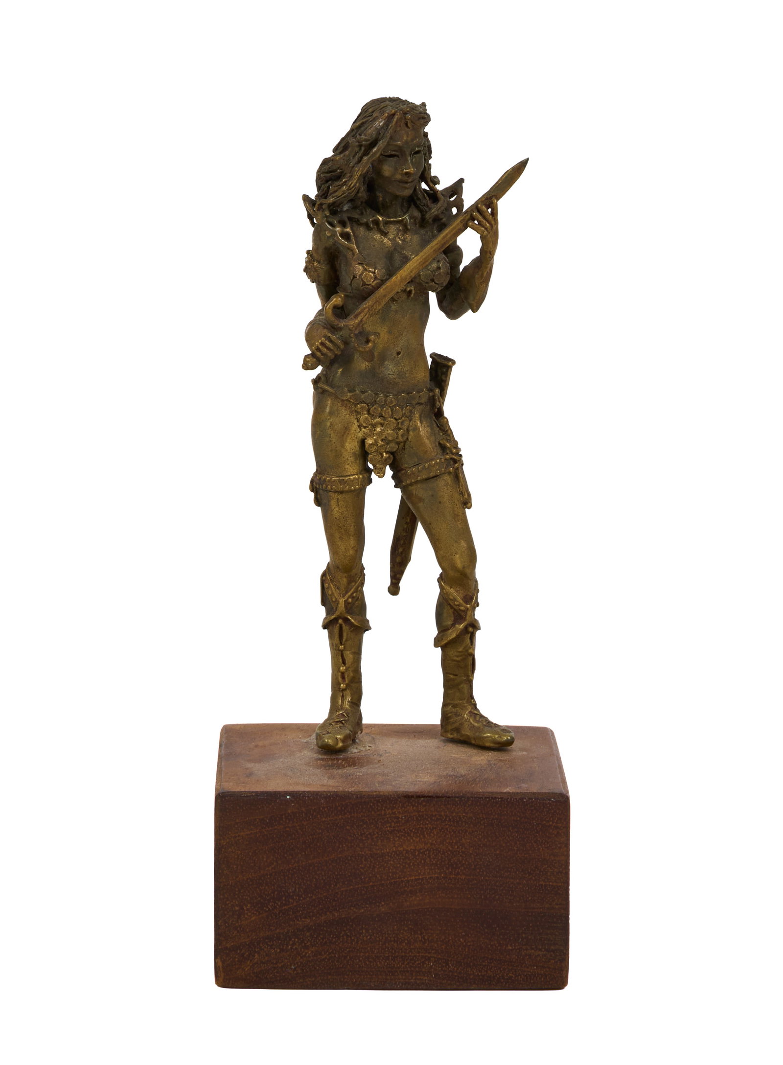 Ann-Margret | 1980s Tabletop Statuette: A small piece; made of brass, depicting a female warrior atop a wooden block.