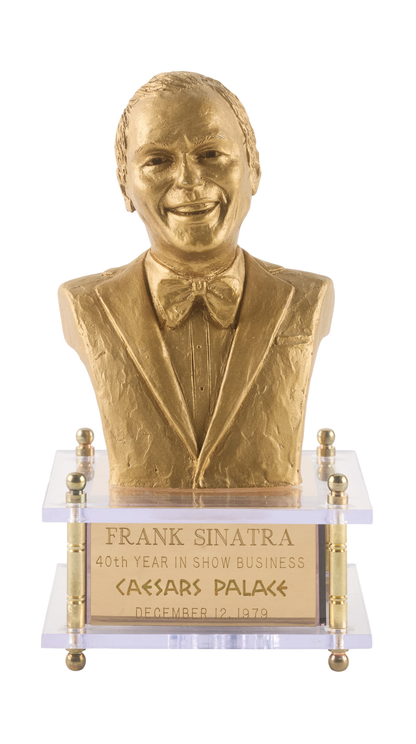 Frank Sinatra | 1979 Music Box: A piece featuring a small gold-tone resin bust of the singer; affixed to a Lucite base with a plaque reading "Frank Sinatra / 40th Year in Show Business / Caesars Palace / December 12, 1979," when