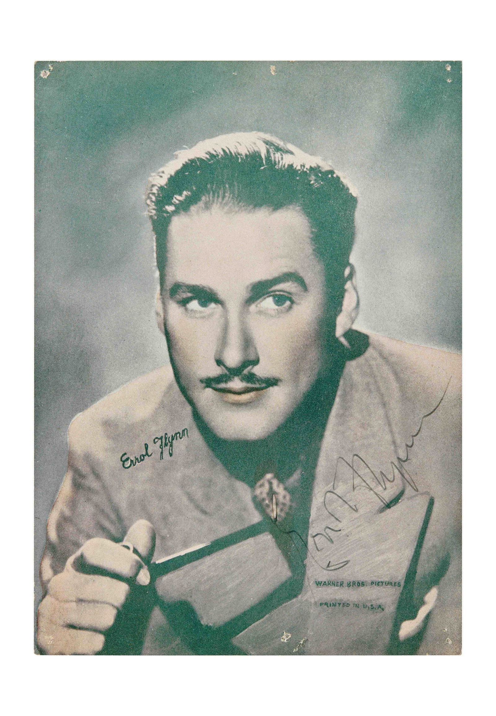 Errol Flynn | Signed Photo Print: A signed headshot of one of the greatest stars of Hollywood's Golden Age, Errol Flynn. An offset lithograph of a hand-painted photo, on semi-glossy paper with clay coating. The portrait shows Flynn