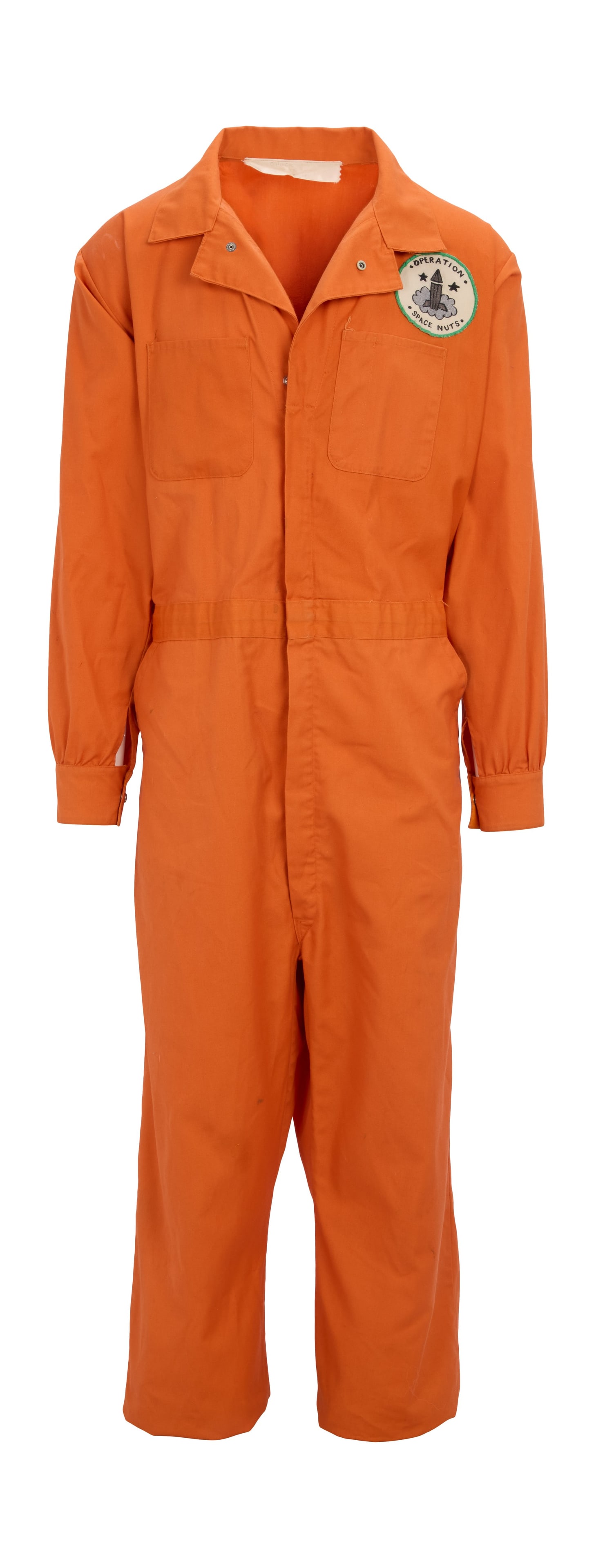 Chuck McCann | 1975 Costume from the Sid and Marty Krofft Television Series "Far Out Space Nuts": An orange jumpsuit and matching orange baseball cap worn by Chuck McCann as "Barney" during the production of Far Out Space Nuts (CBS, 1975). An orange zippered jumpsuit with an "Operation Space
