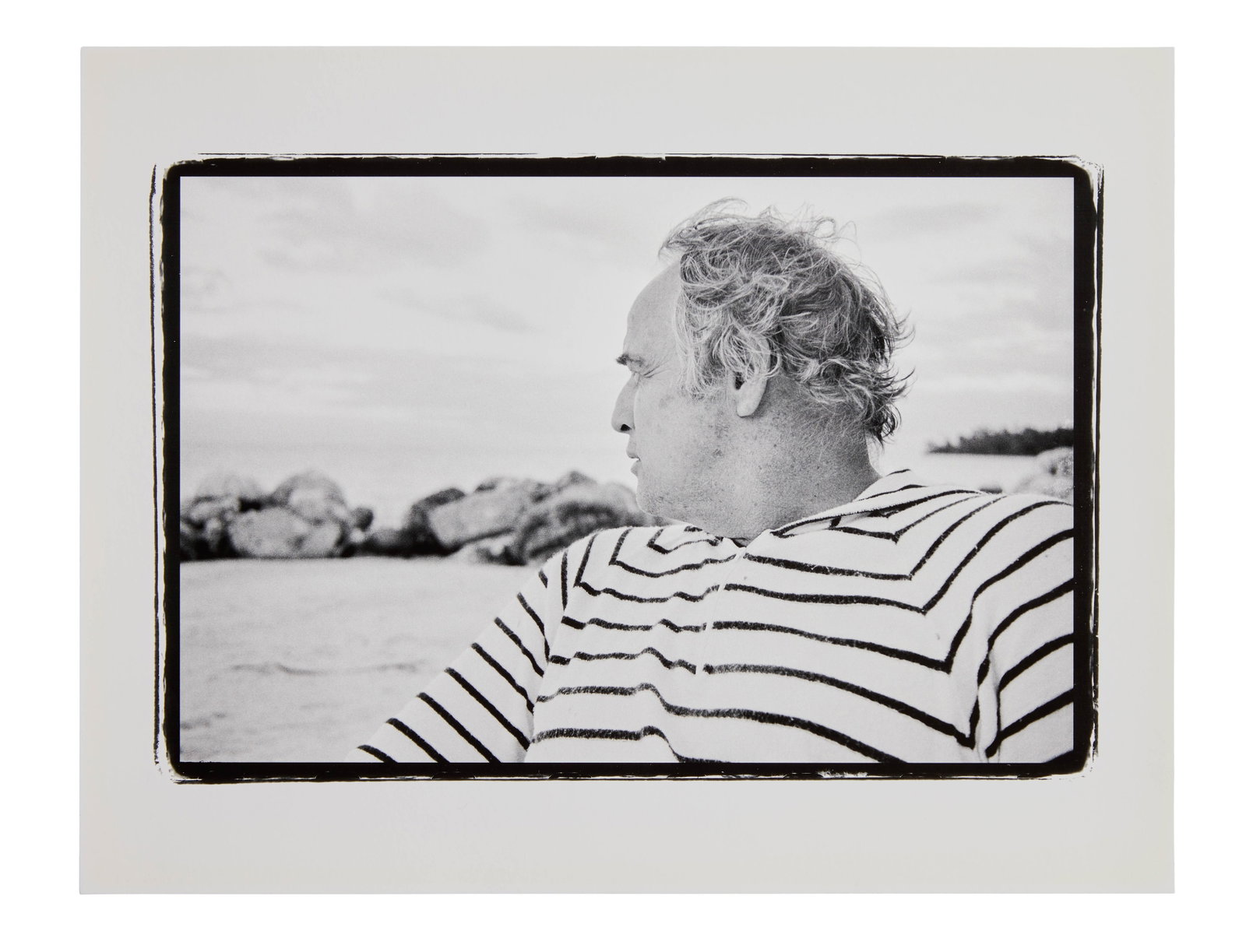Marlon Brando | 1978 Portrait by Lawrence Grobel (B): Original print, double-weight paper, matte finish. A black and white portrait of Marlon Brando at his Tahitian atoll, Teti'aroa. This photograph of the star was taken by journalist Larry Grobel, who