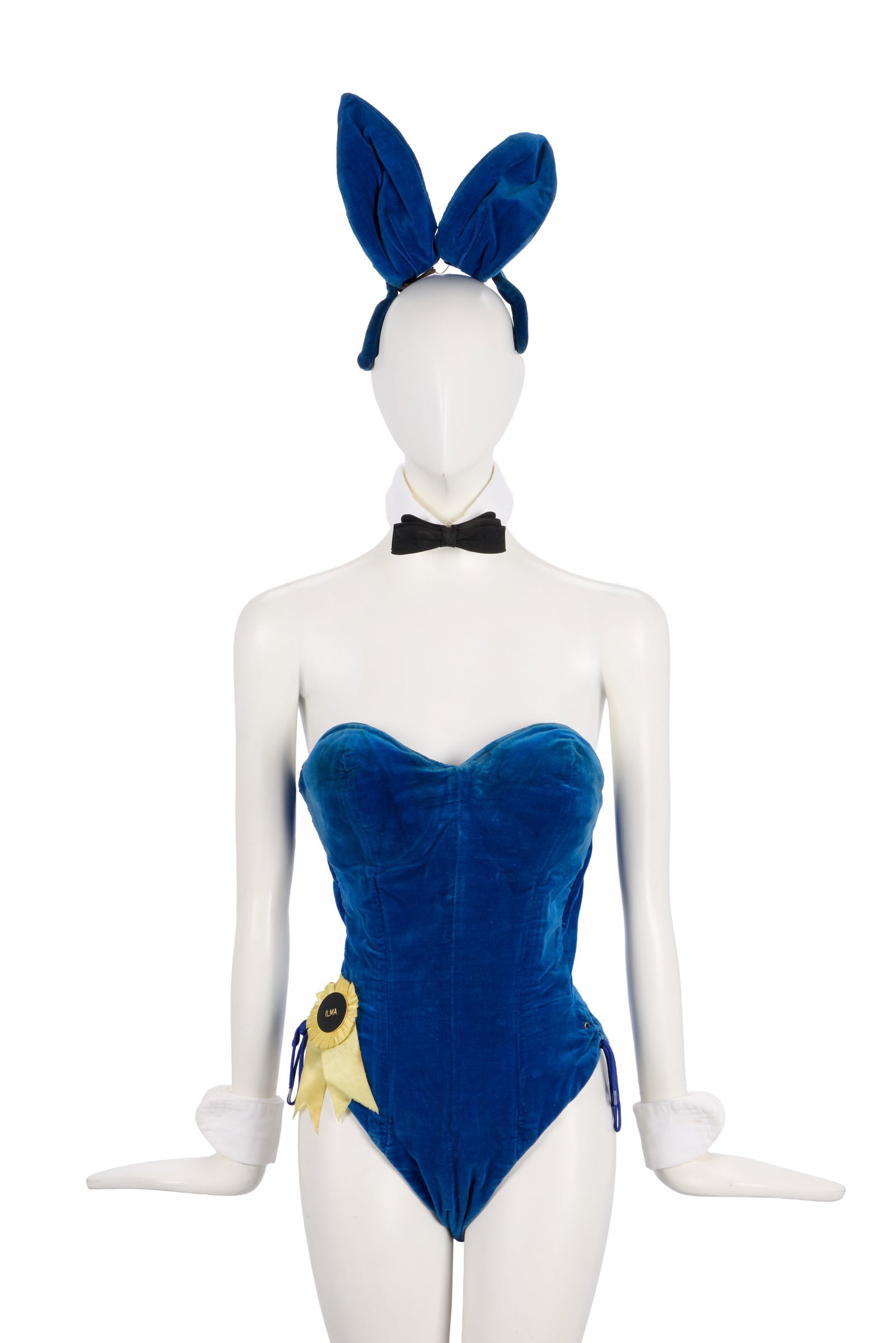 Playboy | 1975 Manchester Playboy Club VIP "Ilma Hynson" Bunny Costume: A Playboy bunny costume worn by Playboy bunny Ilma Hynson at the Playboy Club in Manchester in 1975. The costume consists of a blue strapless boned bodysuit with a plunging neckline and cut high with 