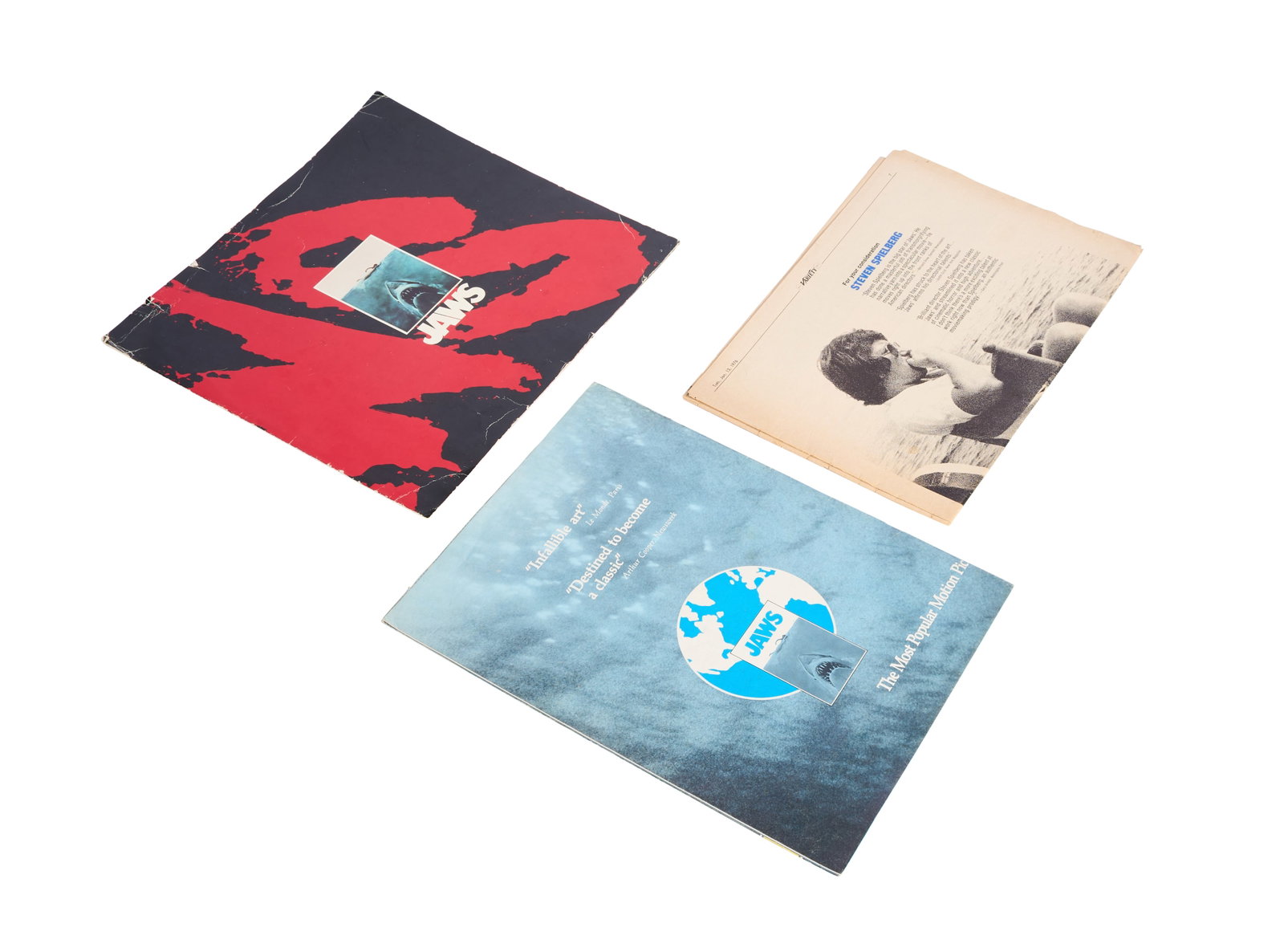 Jaws | Promotional Materials from 1975 and 1976: Three promotional pieces from 1975 and 1976 for the blockbuster classic Jaws (Universal, 1975). Includes: -An original 1975 Universal "open out" promo brochure pressbook. It features the title of the