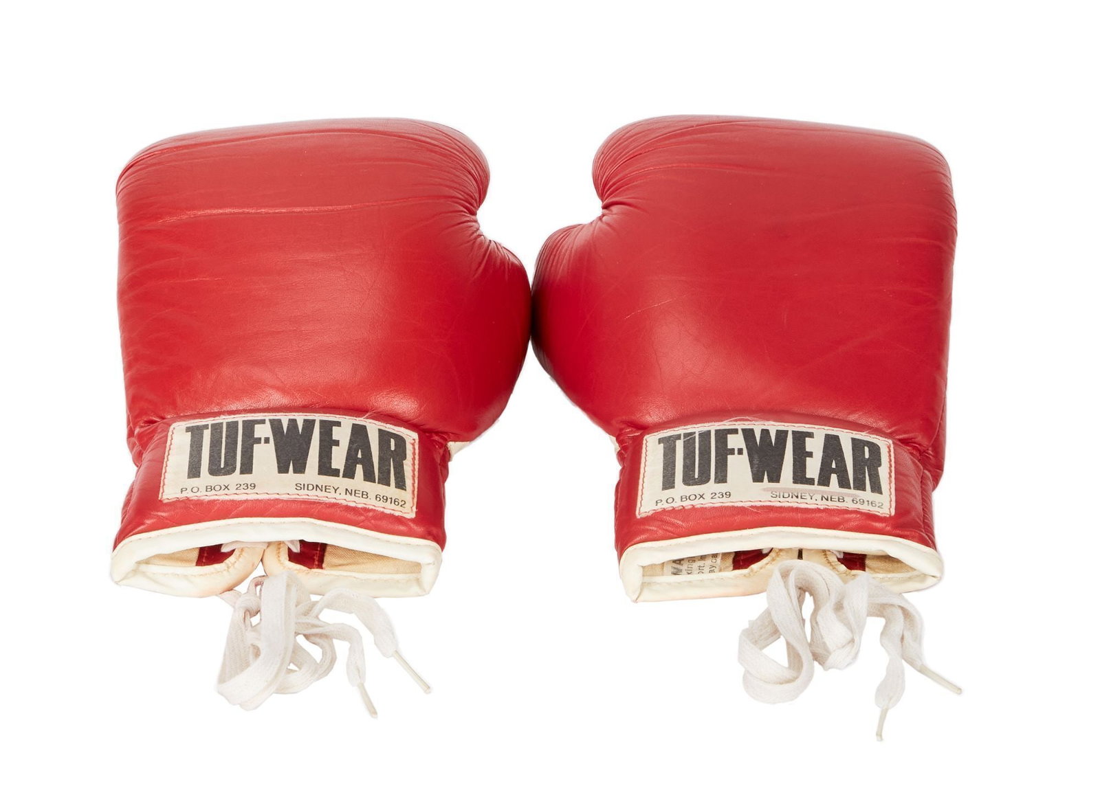 Rocky III | Tuf-Wear Red Boxing Gloves: A pair of red leather Tuf-Wear boxing gloves from the production of Rocky III (United Artists, 1982). Rocky Balboa (Sylvester Stallone) and Clubber Lang (Mr. T) both wear red Tuf-Wear