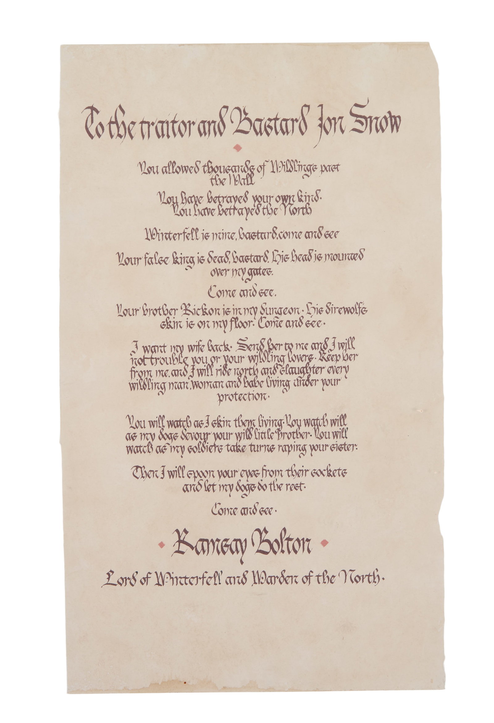Game of Thrones | Ramsay Bolton Scroll to Jon Snow: A prop scroll, from the production of Game of Thrones (HBO, 2011-2019). An original scroll with brown text printed on aged parchment paper, which has been rolled and is secured by a dark brown