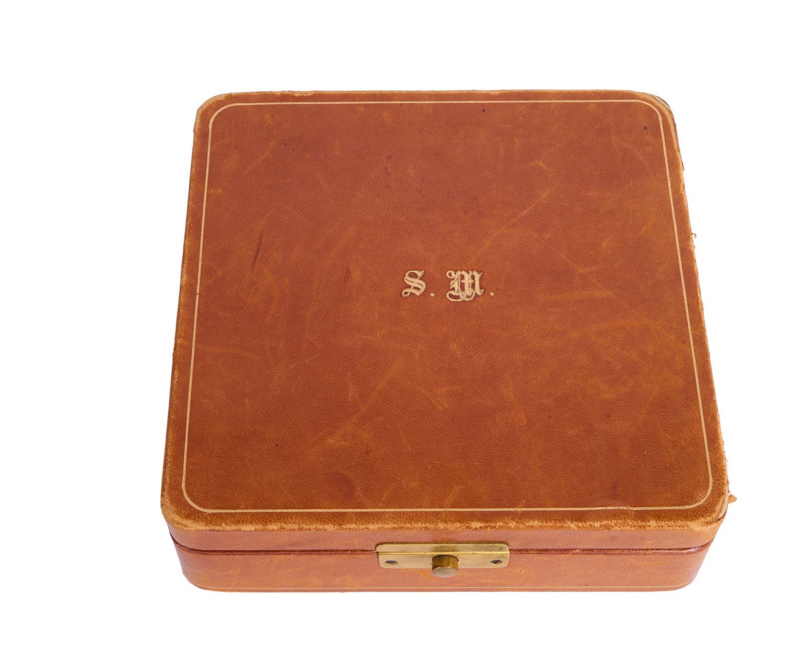 Steve McQueen | Monogrammed Travel Jewelry Box: A monogrammed travel jewelry box, gifted to Steve McQueen by his first wife, Neile McQueen, in the 1960s. The light brown leather box features the initials "S.M." on the top lid. Accompanied by an ori