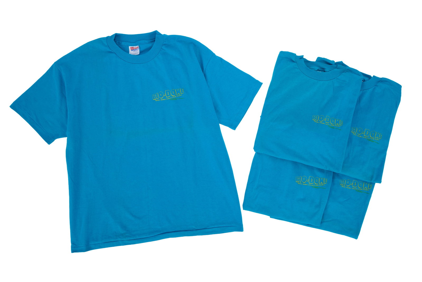 Bio-Dome | Promotional Shirts: Five blue promotional shirts for the Pauly Shore and Stephen Baldwin-starring comedy Bio-Dome (MGM/UA, 1996), featuring the film's title printed in yellow on the proper left chest alongside the