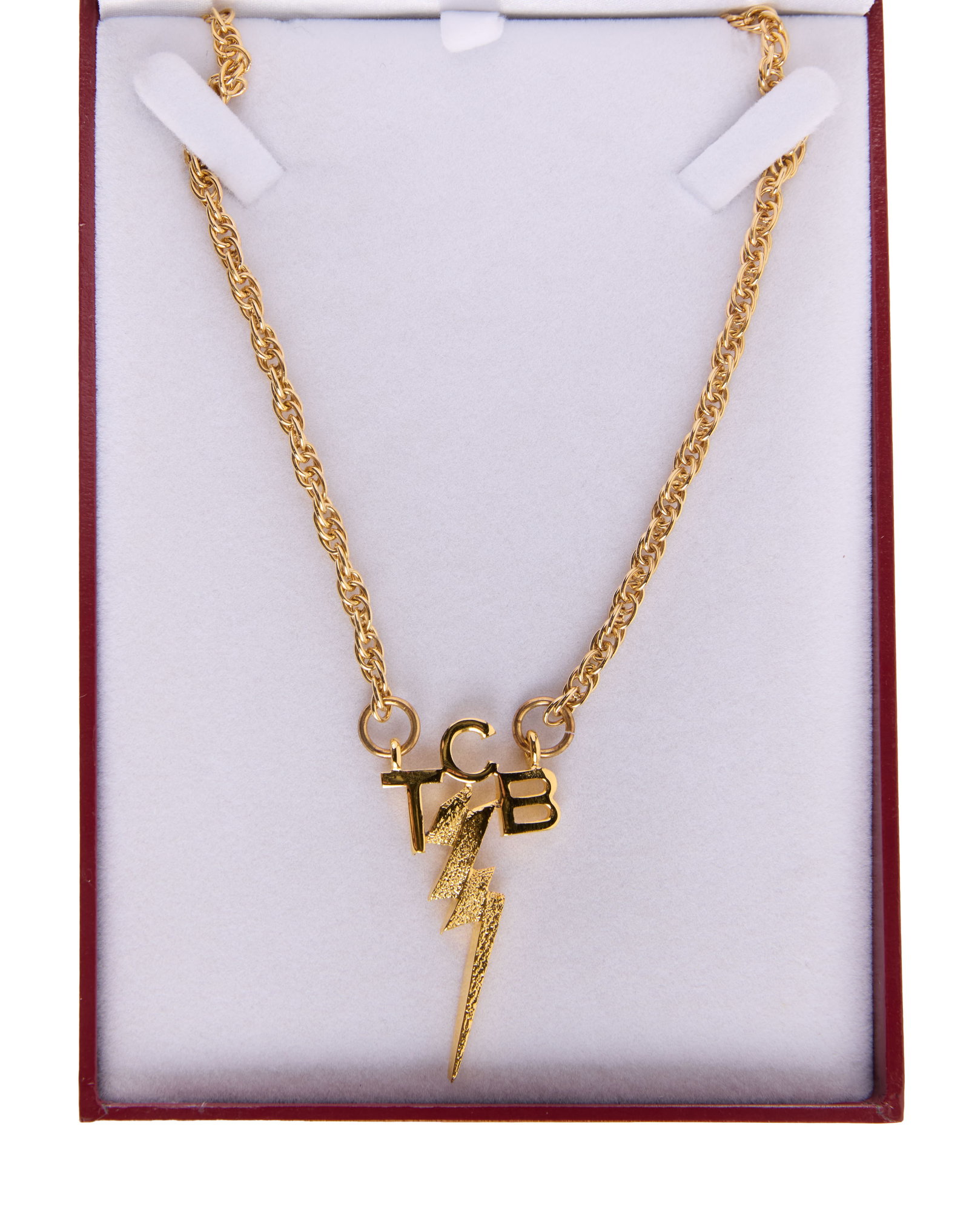 Elvis | "TCB" Necklace with Baz Luhrmann Signed Box: A gold-tone chain necklace with "TCB" pendant from the production of the rock ?n roll biopic Elvis (Warner Bros, 2022). This necklace was created for the film?s star, Austin Butler, in the style of