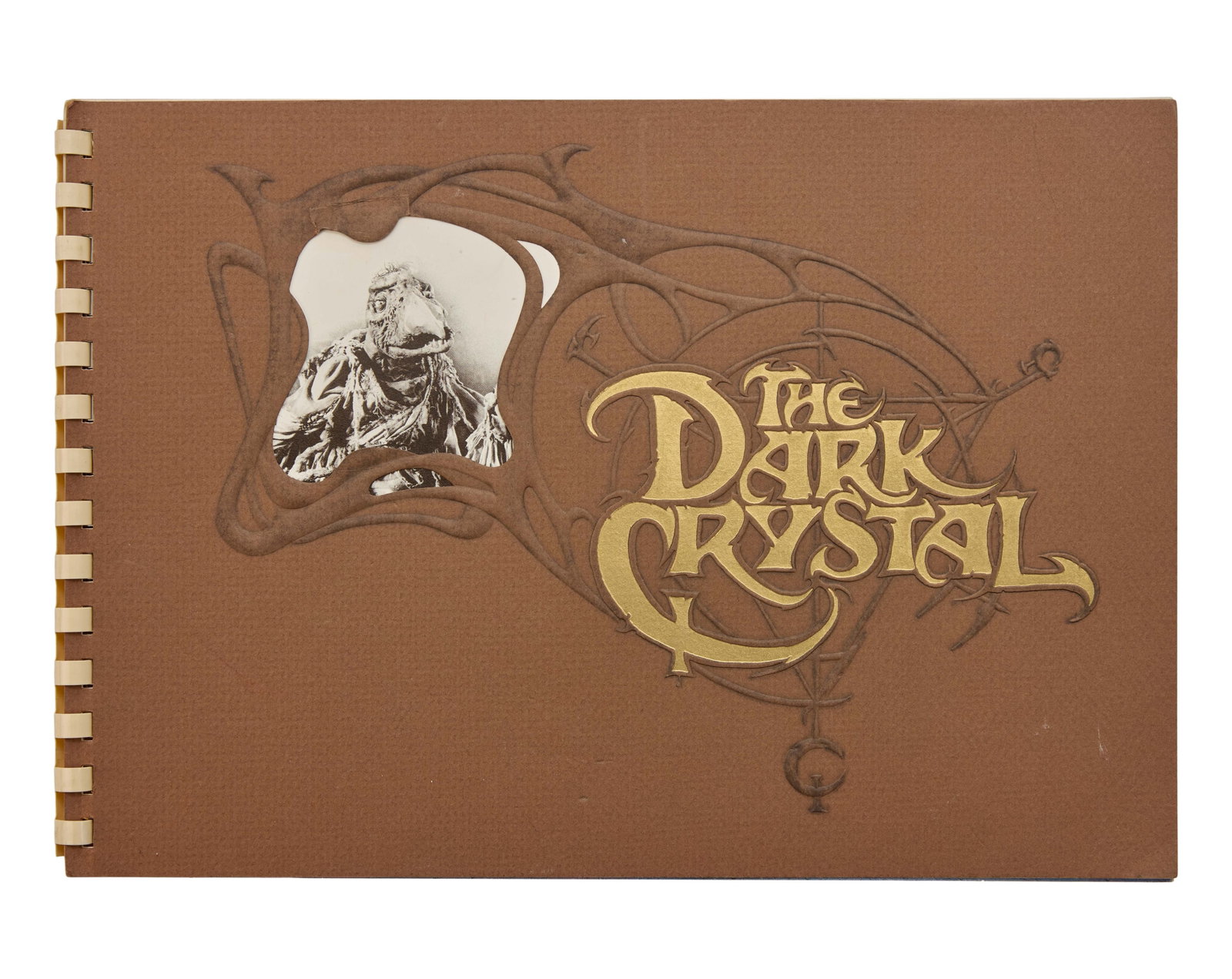 The Dark Crystal | Jim Henson Signed Press Book: An original spiral-bound press book for The Dark Crystal (Universal Pictures Associated Film Distribution, 1982) signed by producer and co-director Jim Henson in pencil on the first page. The pre