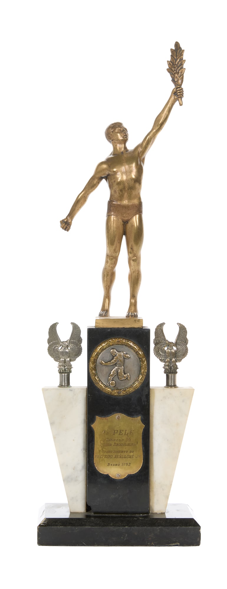 Pele | 1958 Honorary Bauru Trophy: A trophy presented to Pele in 1958, honoring him as the symbol of Brazilian character. The plaque is engraved, "Ao Pele Simbolo da Fibra Brasileira! Oferecimento do Prefeito Avallone Jr. - Bauru 1958.