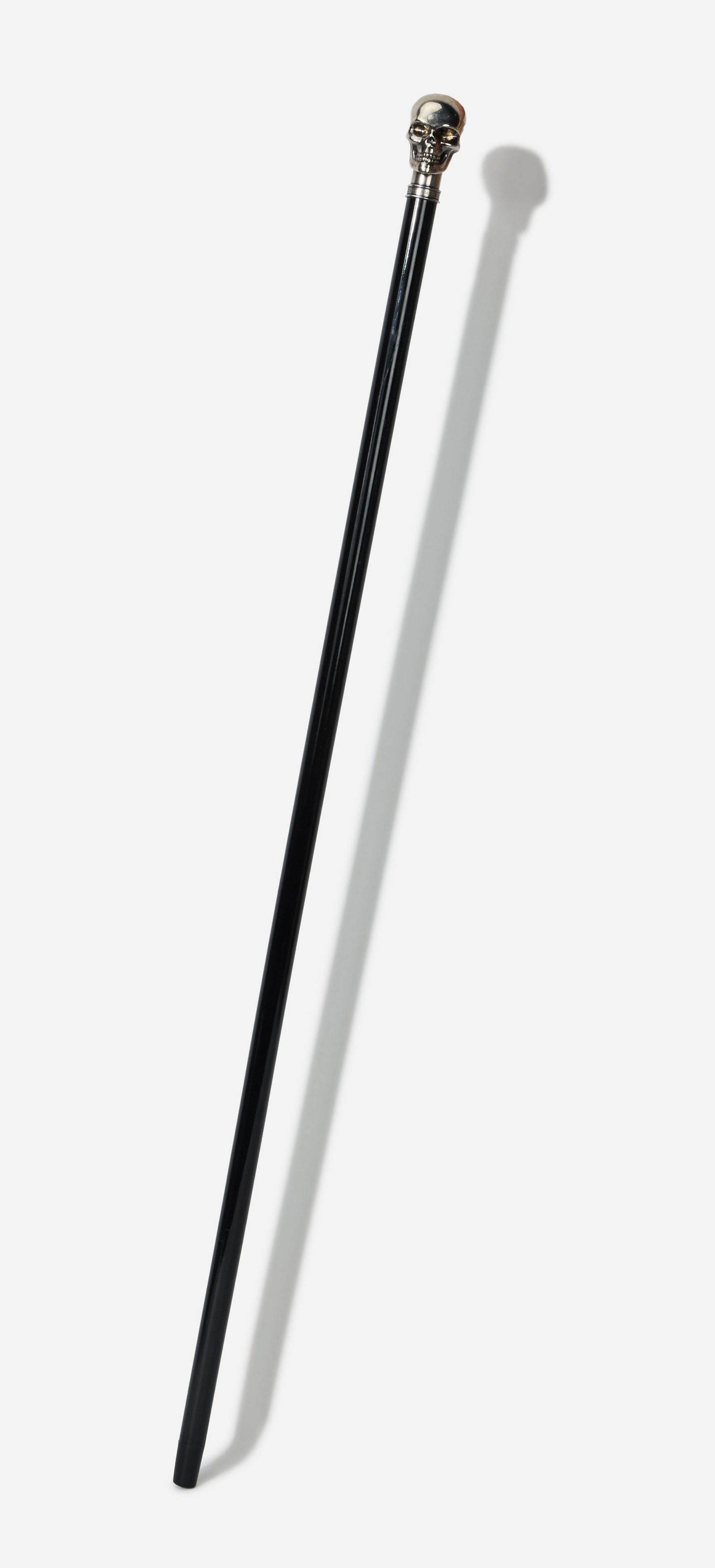Boy George | Alexander McQueen Dandy Skull Cane: This an Alexander McQueen black resin cane with a metal skull head from the collection of Boy George. The cane is marked "Made in Italy" etched in the metal. The design and aesthetic were meant