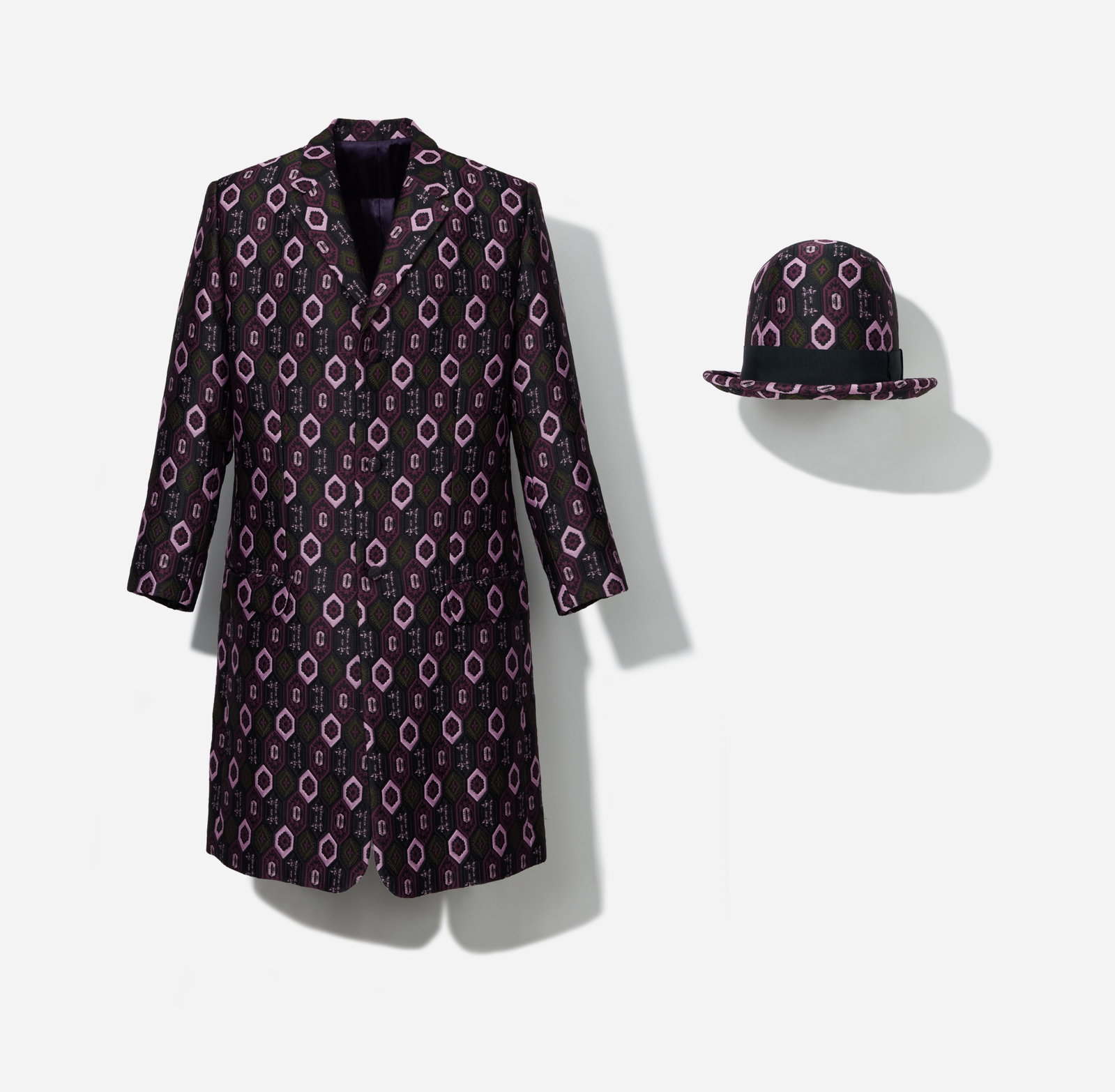 Boy George | Geometric Jacquard Pattern Coat and A Child of the Jago Bowler Hat: Coat and A Child of the Jago bowler hat from the collection of Boy George. The coat and hat are composed of a polyester brocade and features an allover geometric jacquard pattern in pink, plum, 