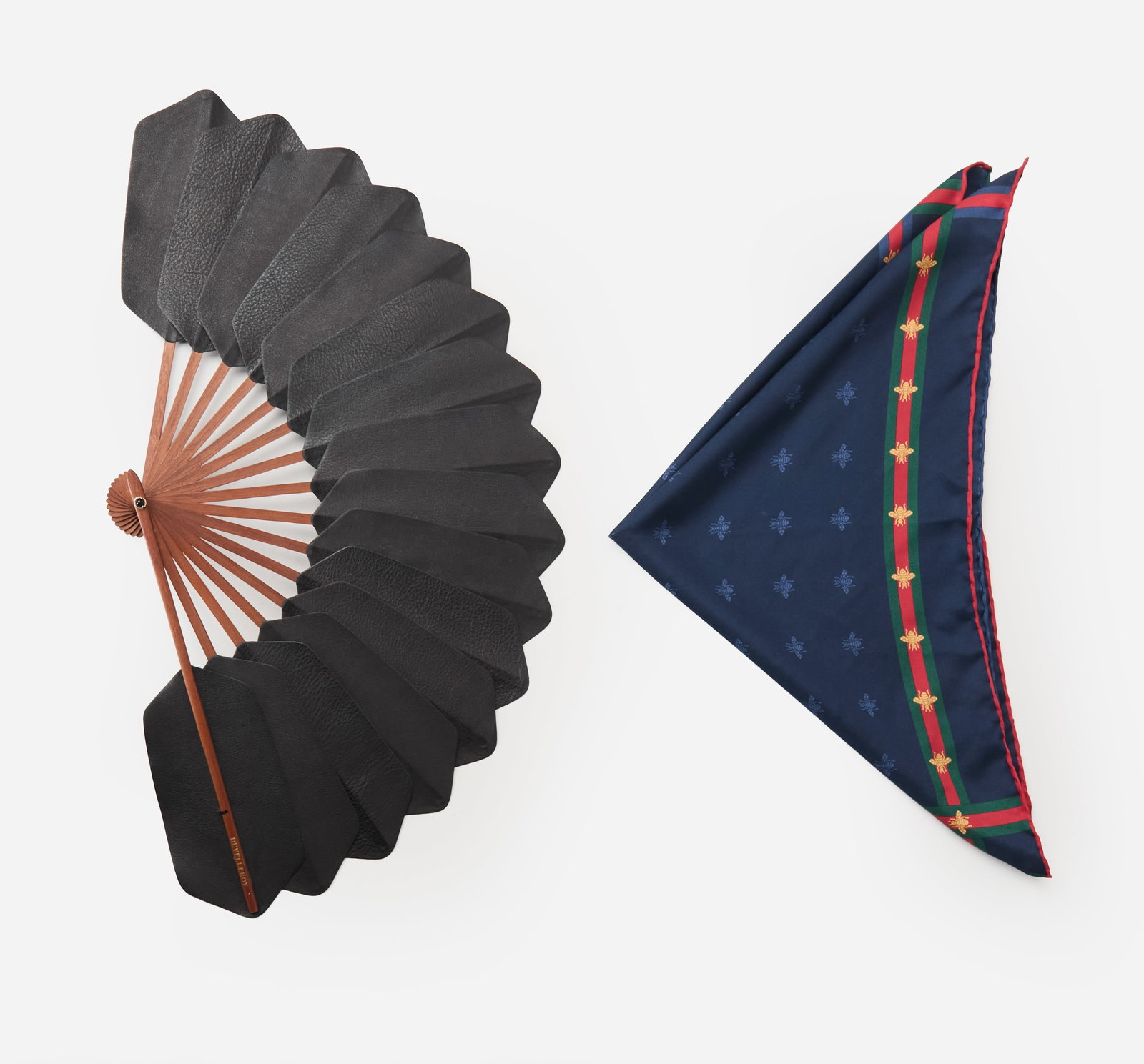 Designer Accessories | Gucci Pocket Square and Duvelleroy Fan: Two Designer Accessories featuring a Gucci pocket square and Duvelleroy hand fan from the collection of Cameron Silver. The navy pocket square is composed of 100% silk and features an all-over print o