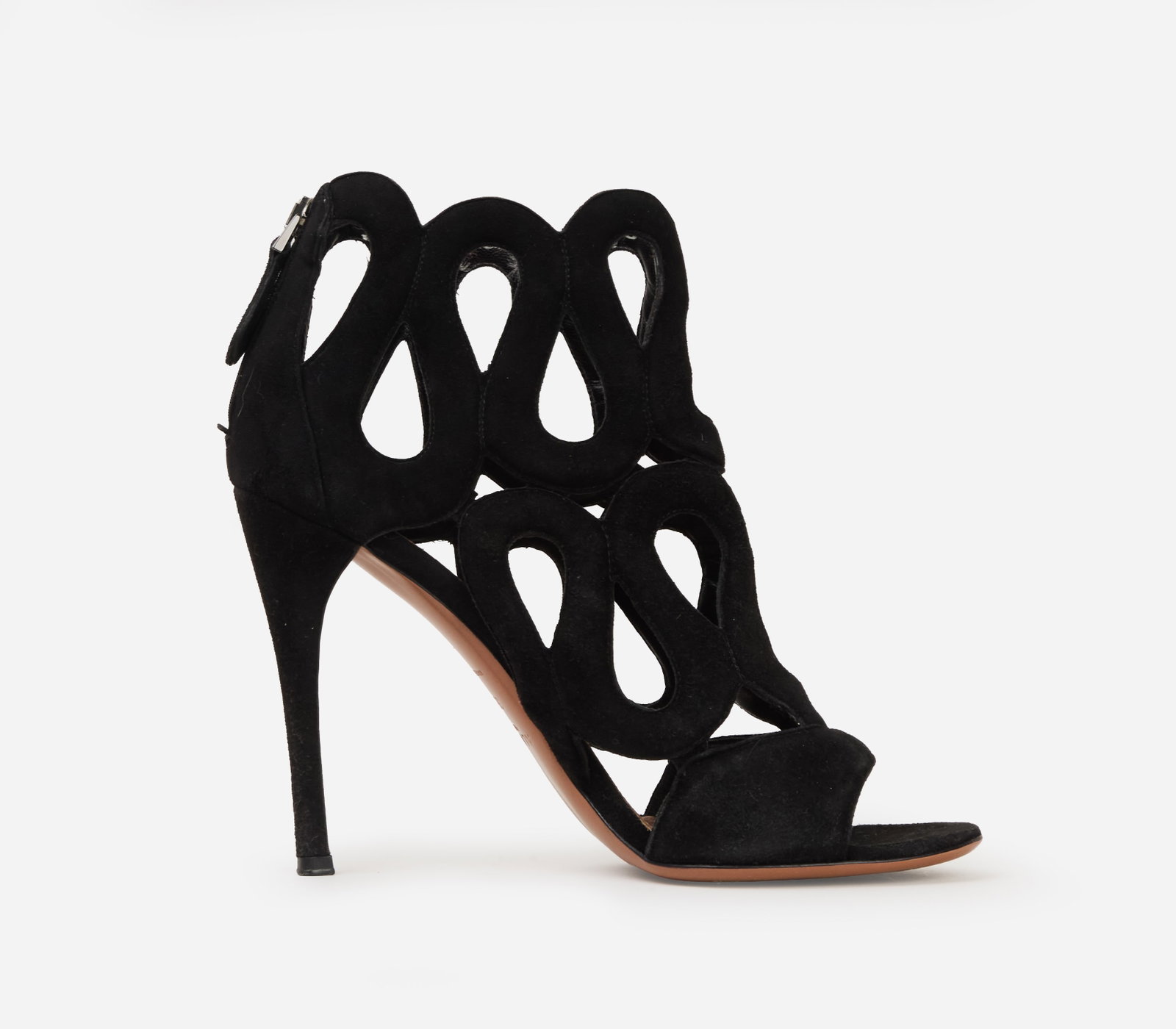 Alaïa | Suede Stiletto Sandals: Alaïa black suede stiletto heels. Open-toe stiletto sandals featuring a cage-style upper composed of oversized teardrop-shaped cutouts that wrap around the foot and ankle. The back of the heel