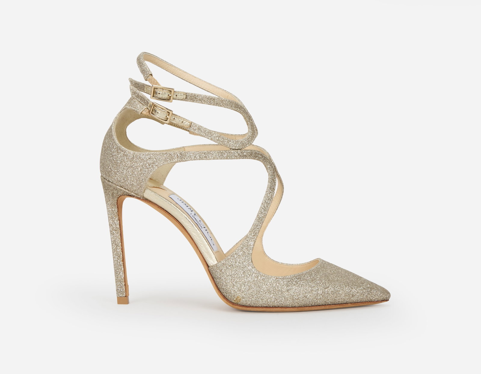 Jimmy Choo | Silver Glitter Stilettos: A pair of Jimmy Choo silver metallic glitter strappy stilettos. Both shoes have beige leather lined in soles and beige leather outer soles, marked a size 37.