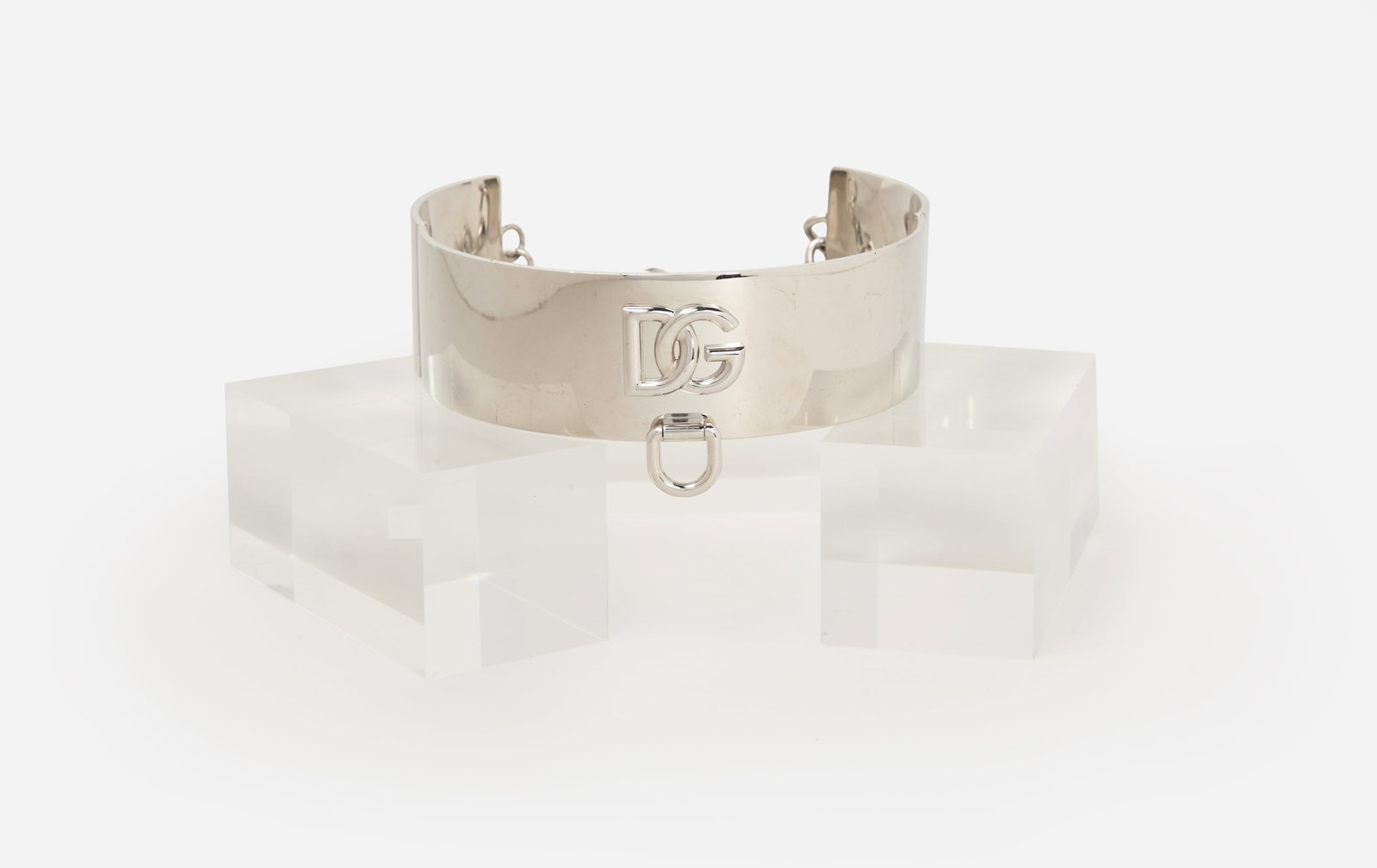 Dolce & Gabbana | Silver Collar Necklace: A monogram silver tone collar, chocker style necklace with DG monogram at the front center from the collection of Cameron Silver. Necklace has a lobster-claw clasp with a chain-link extension. There