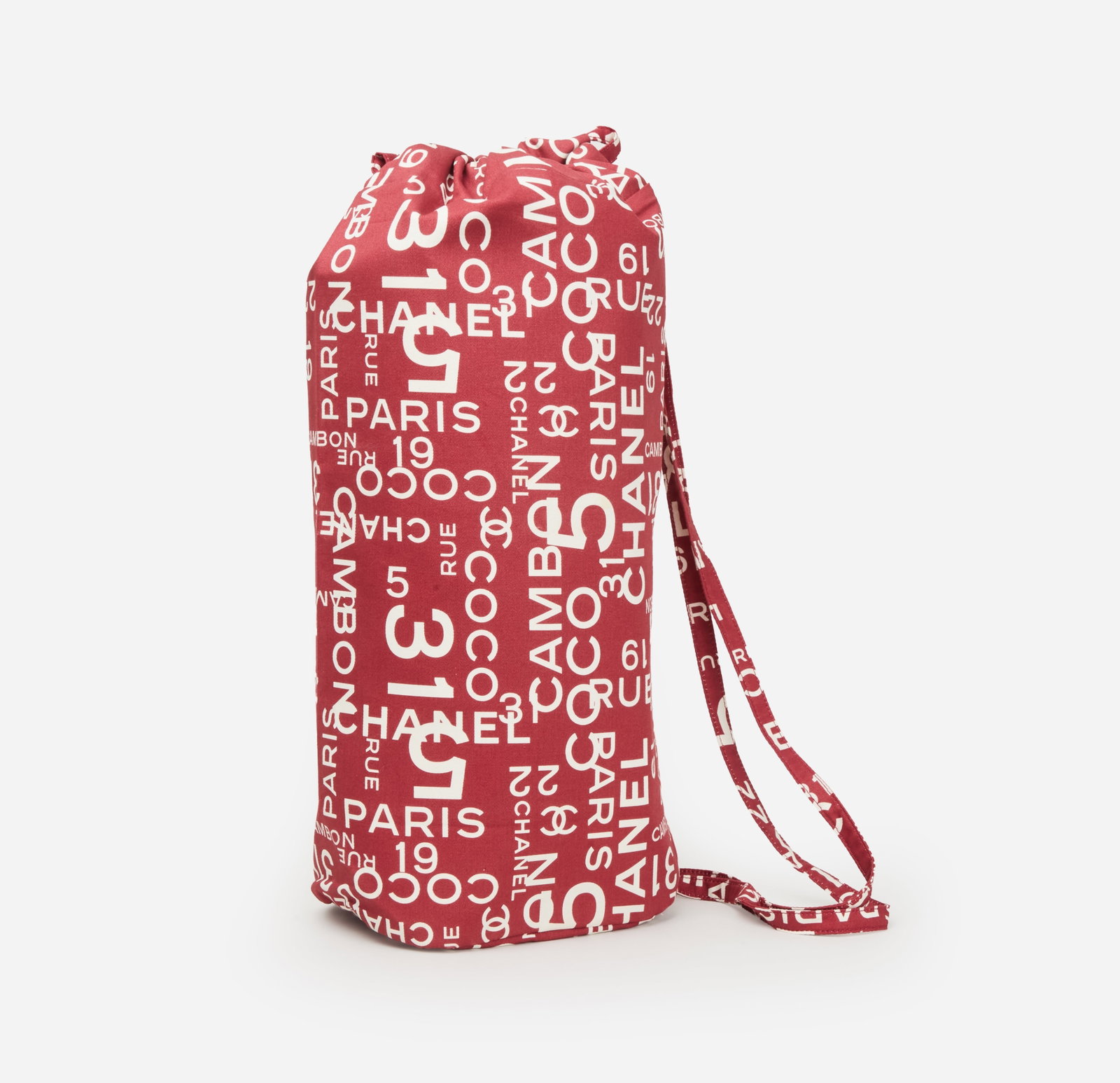 Chanel | 2002 "31 Rue Cambon" By the Sea Canvas Backpack: Chanel 31 Rue Cambon canvas backpack from the "By The Sea" collection from 2002-2003 designed by Karl Lagerfeld. The bag is composed of 100% cotton featuring an allover white graphic logo print compos