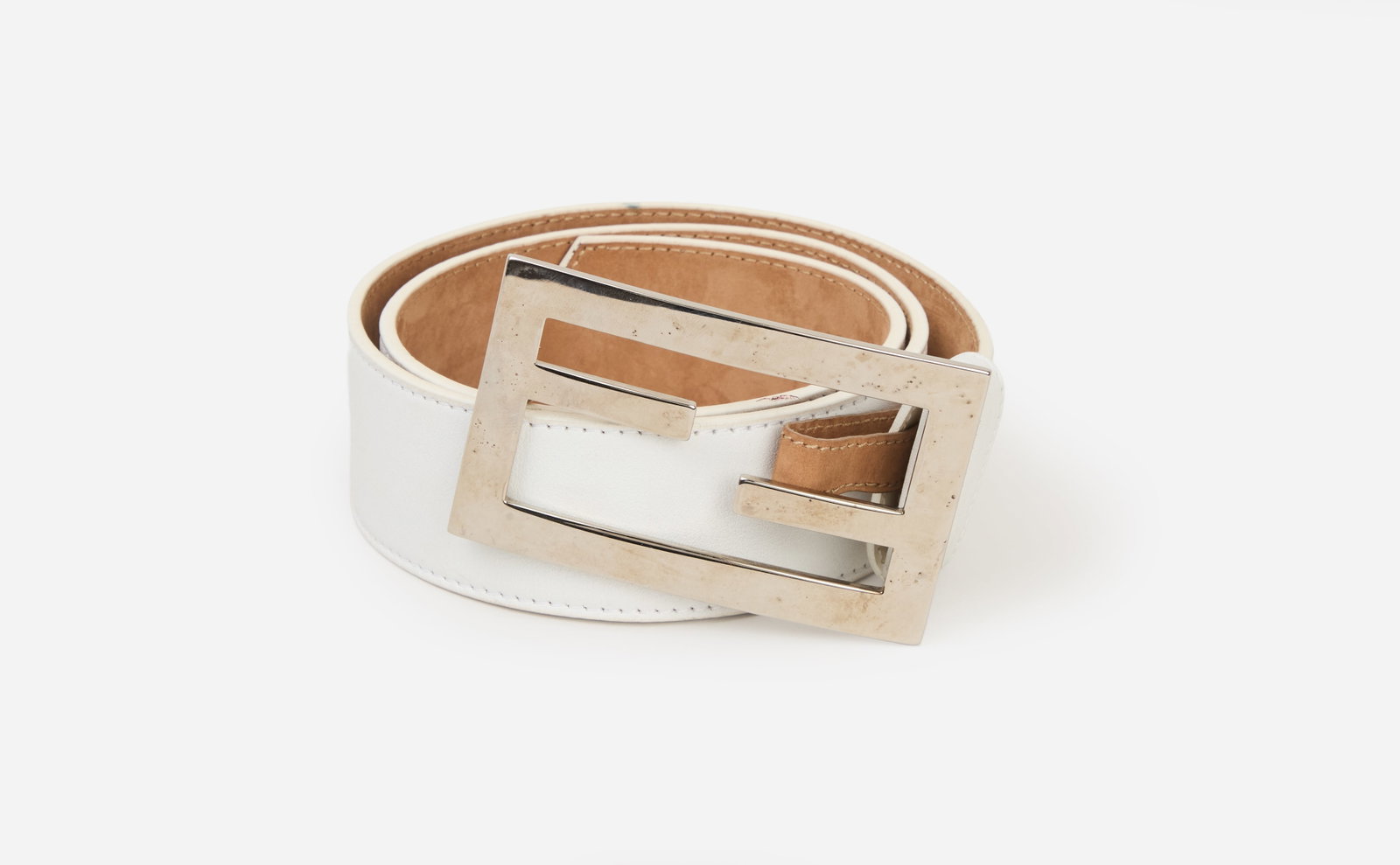 Fendi | 2000's Zucca Logo Belt: A Fendi belt with silver-tone Zucca logo buckle with a wide white leather strap. This belt is likely from 2000s and designed during Karl Lagerfeld's design tenure. The reverse of the belt is lined in