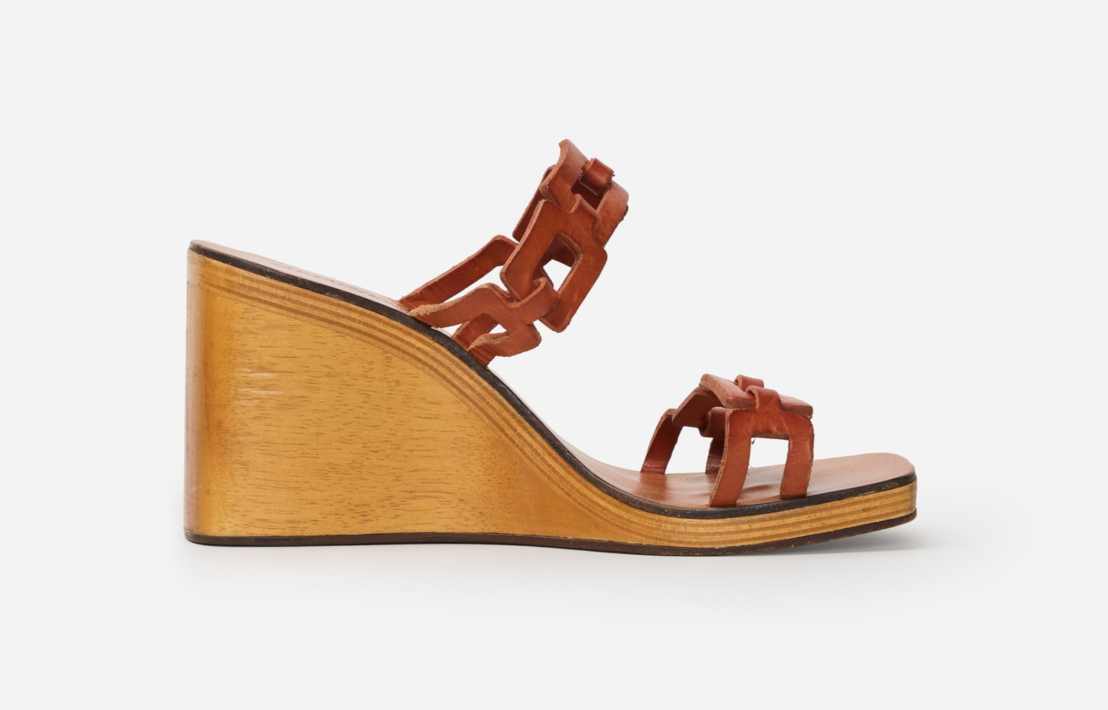 Carolyn Bessette Kennedy | 1990s Stephane Kélian Wedges: A pair of Stephane Kélian wedges with link leather straps belonging to Carolyn Bessette-Kennedy. The design features wooden wedges with leather insoles with linked leather straps below the