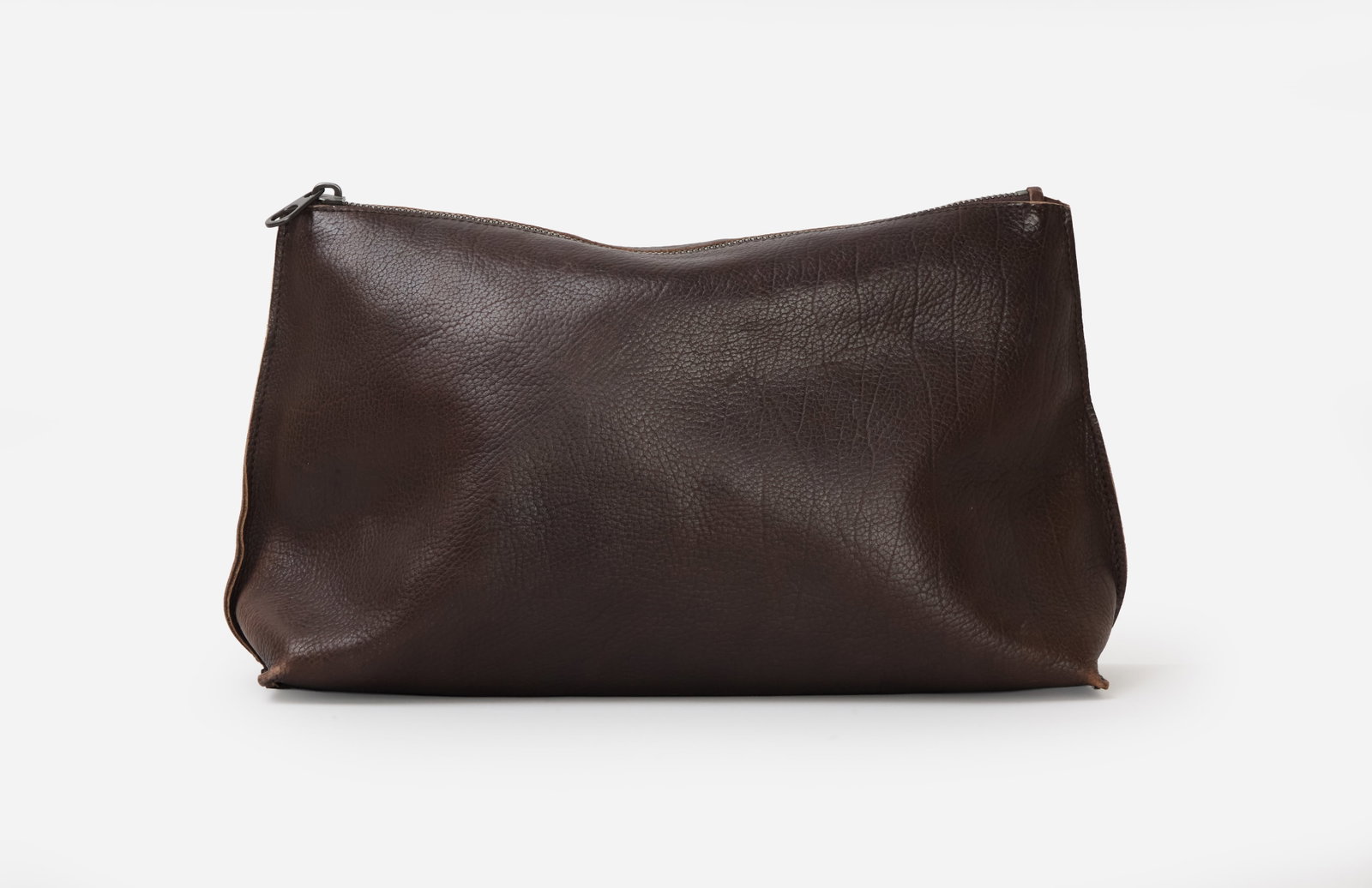 Bottega Veneta | Brown Leather Clutch: Bottega Veneta brown leather clutch purse. The bag features a pebbled texture and a top zip closure that opens to the interior. The interior includes a patch engraved with "Bottega Veneta Made in